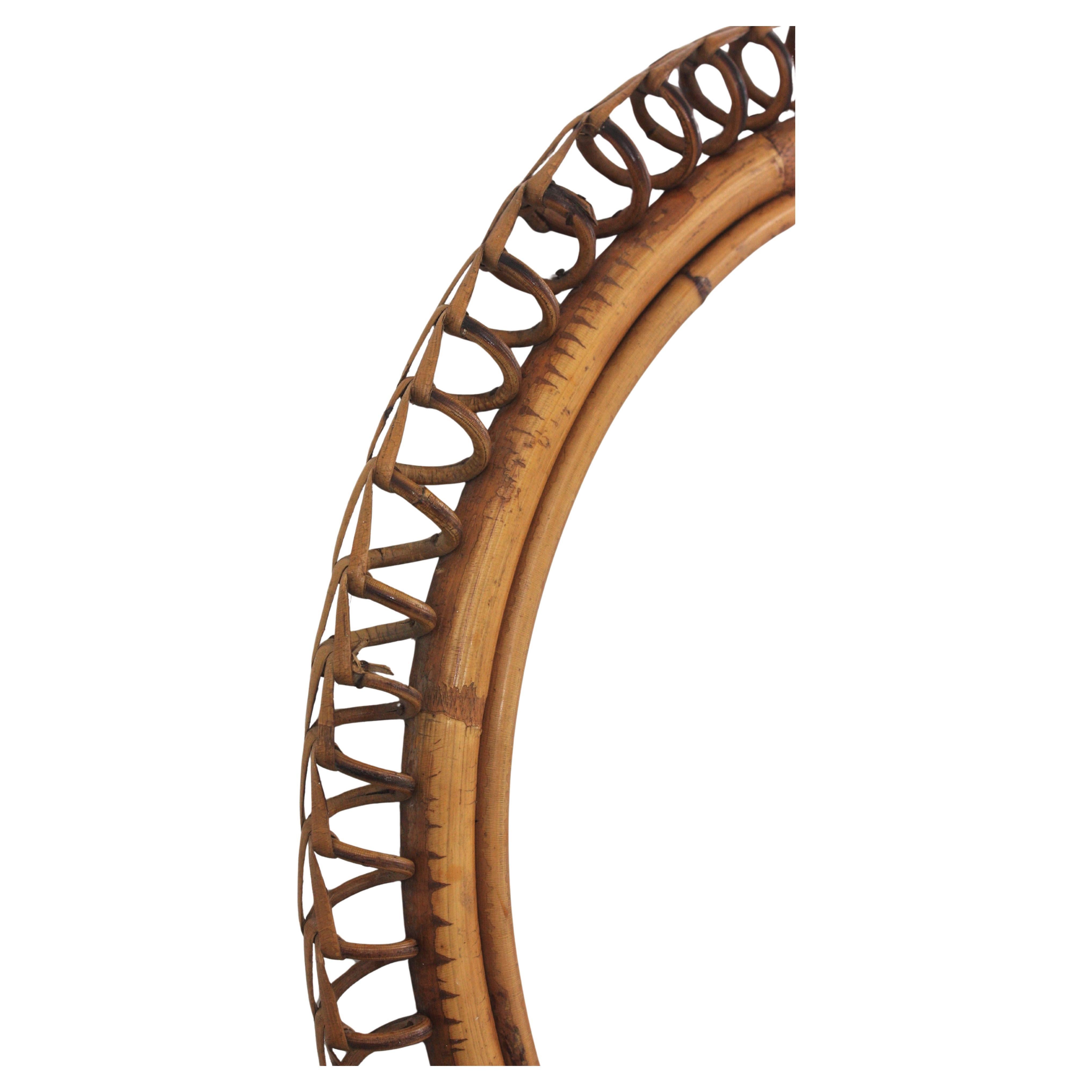 Italian Mid-Century Modern spiral framed mirror in rattan by Franco Albini. Italy, 1950s-1960s
This cool round mirror features a rattan woven spiral frame surrounding the central glass and hanging from a rattan ring.
Place it alone or as a part of a