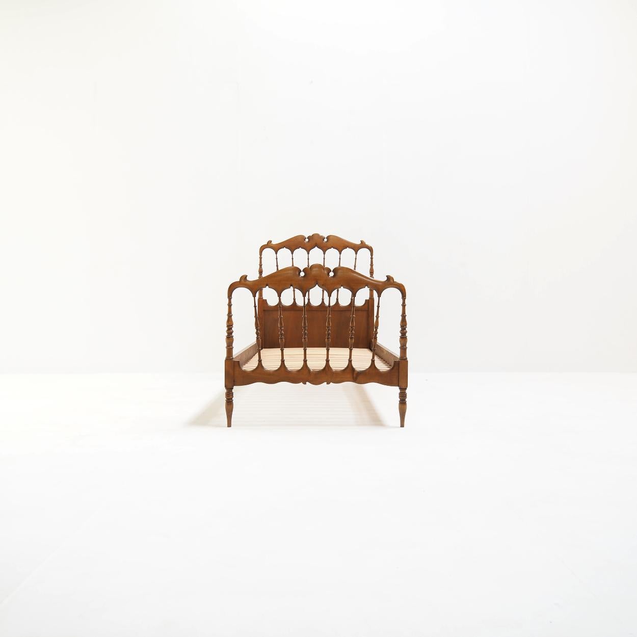 Very decorative bed made in the famous Italian village of Chiavari after a 19th century design by Gaetano Descalzi.

The bed is made of solid and multiplex pine and stands surprisingly sturdy on its legs considering its age.

It has normal signs of