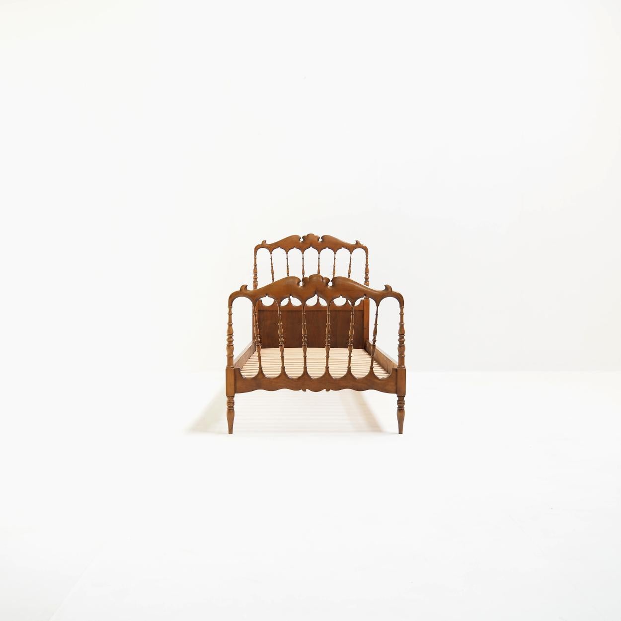 Very decorative bed made in the famous Italian village of Chiavari after a 19th century design by Gaetano Descalzi.

The bed is made of solid and multiplex pine and stands surprisingly sturdy on its legs considering its age.

It has normal signs of