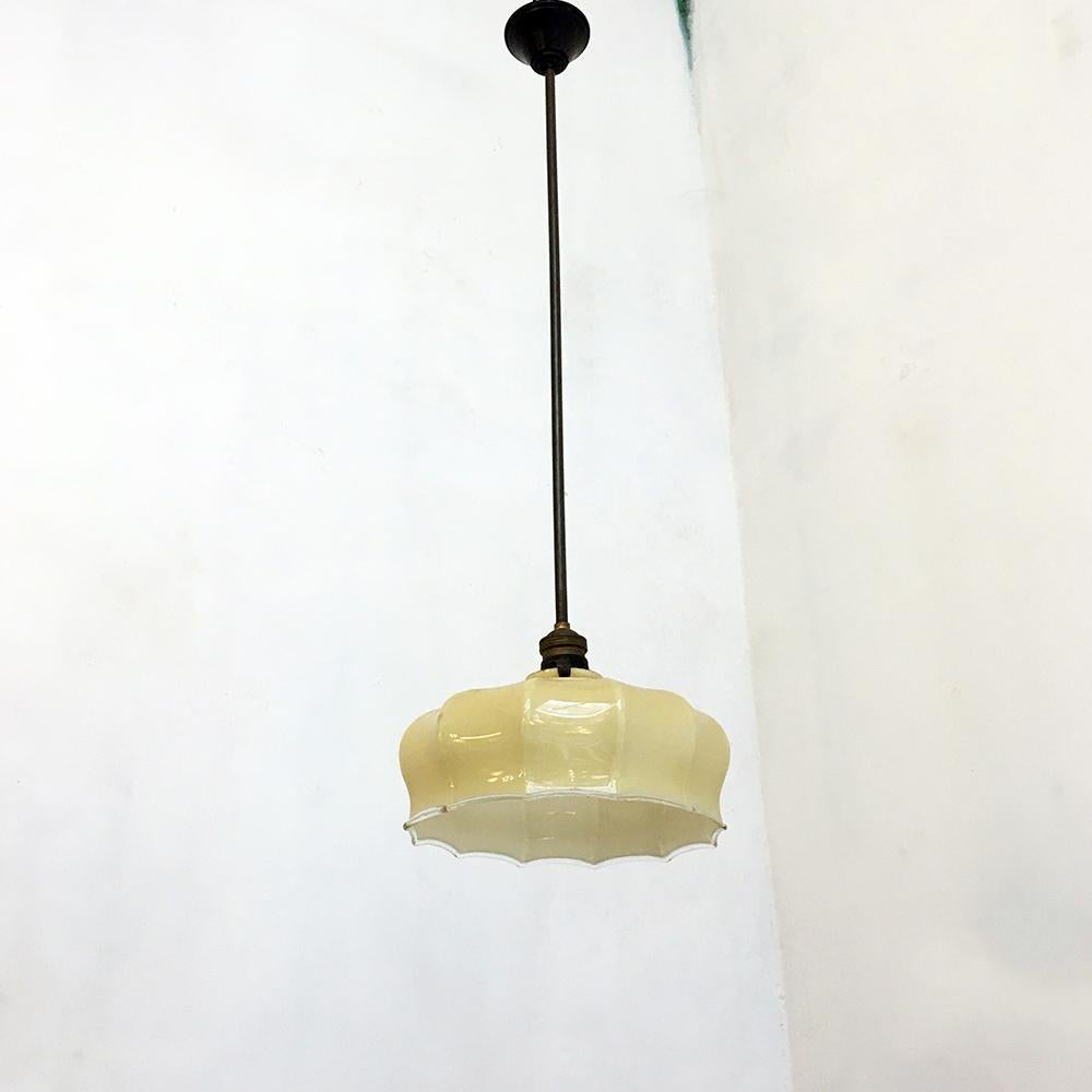 Italian classic vintage glass and brunished brass chandelier, early 900s
Italian glass suspension with brunished brass stem, dating to the start of last century. Classic shape, with yellow-off glass lampshade and decoration on the perimeter of the