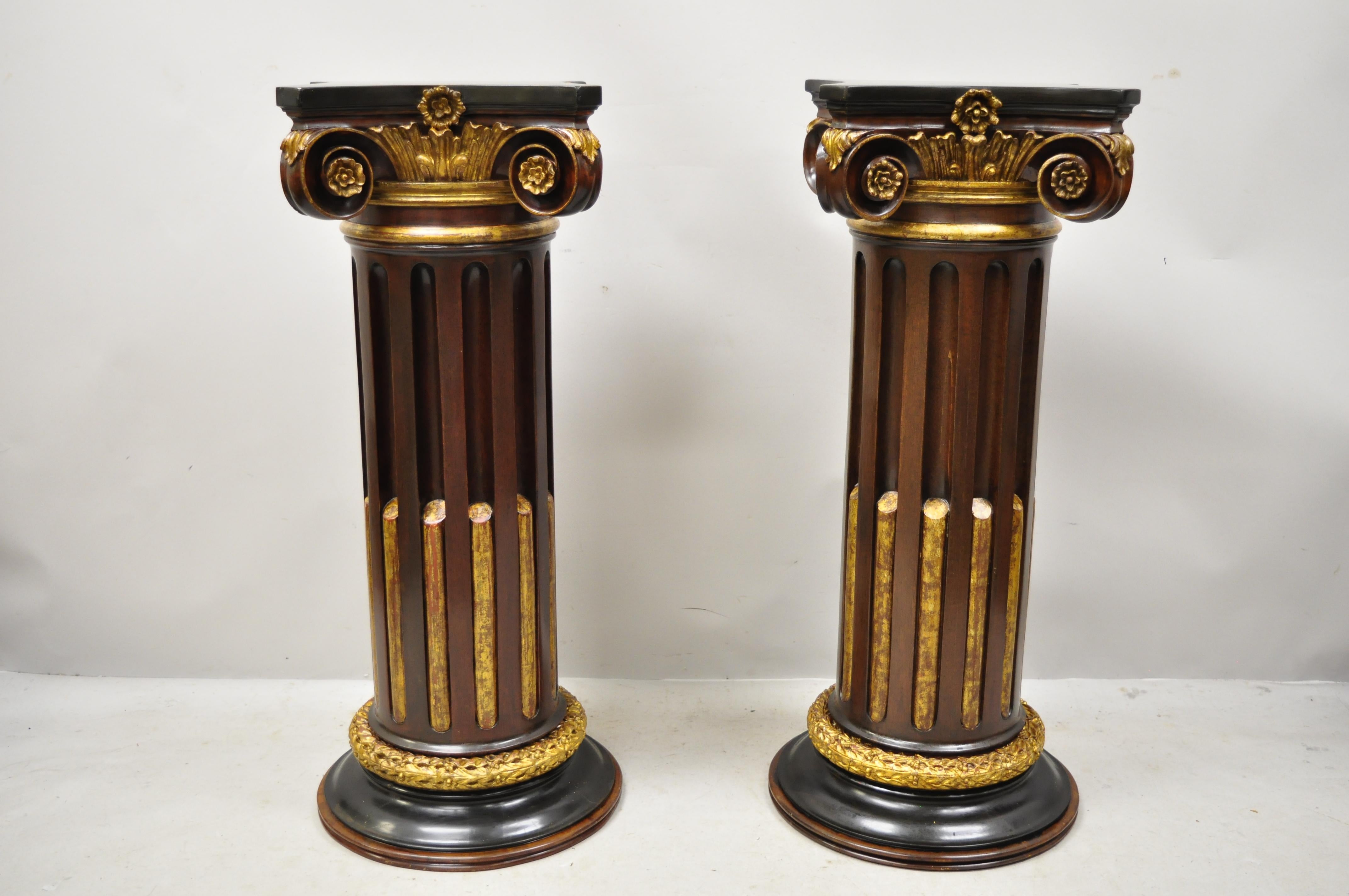 20th century Italian Classical carved wood polychrome gold gilt Corinthian column pedestals - a pair. Item features gold gilt polychrome finish, acanthus and leafy scrollwork, heavy solid wood construction, distressed finish, nicely carved details,