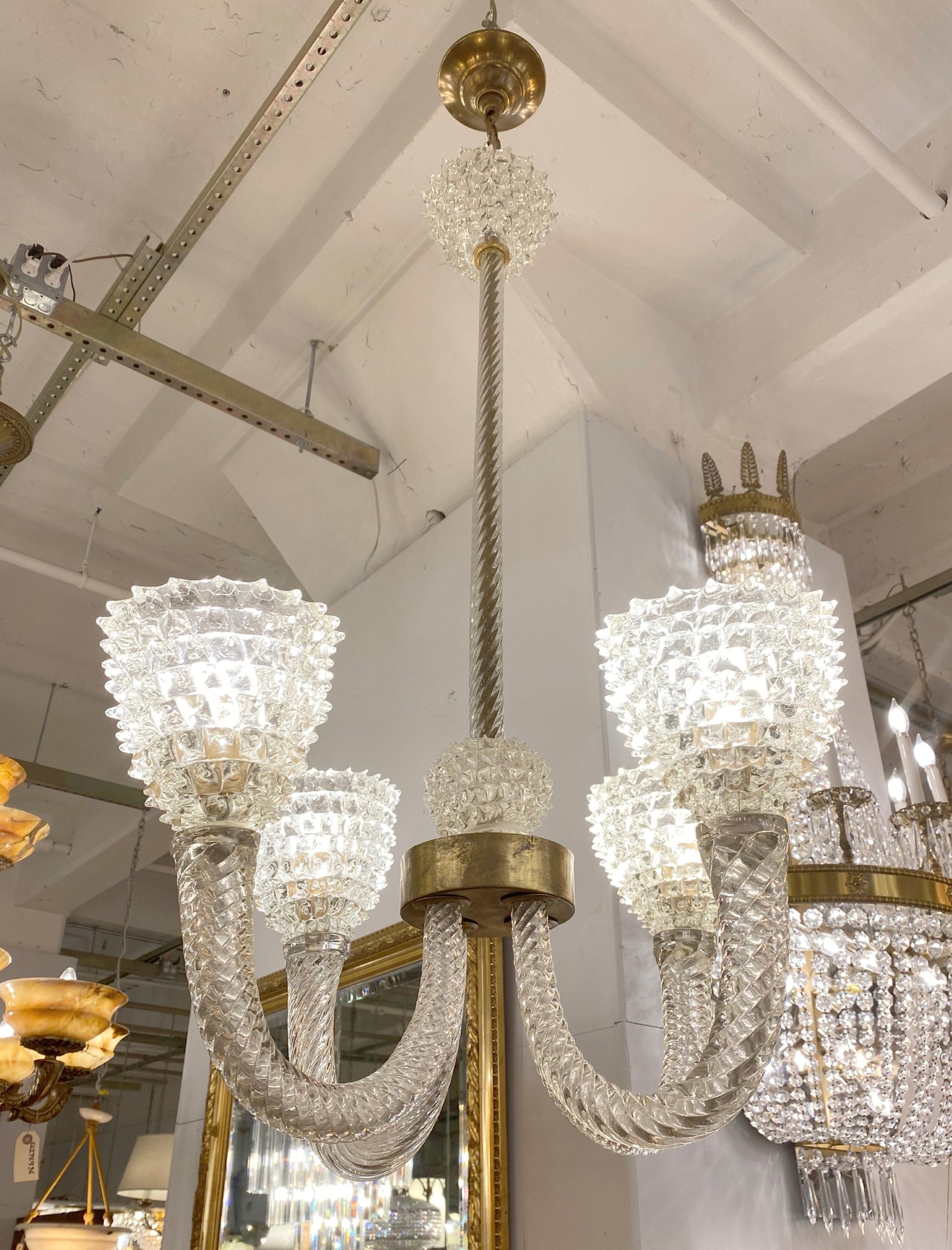 20th century four light chandelier manufactured out of clear Giaccio Murano glass mounted on a brass frame. Ghiaccio is the Italian word for ice applied here as the term for glass resembling crushed ice. Cleaned and restored. Please note, this item