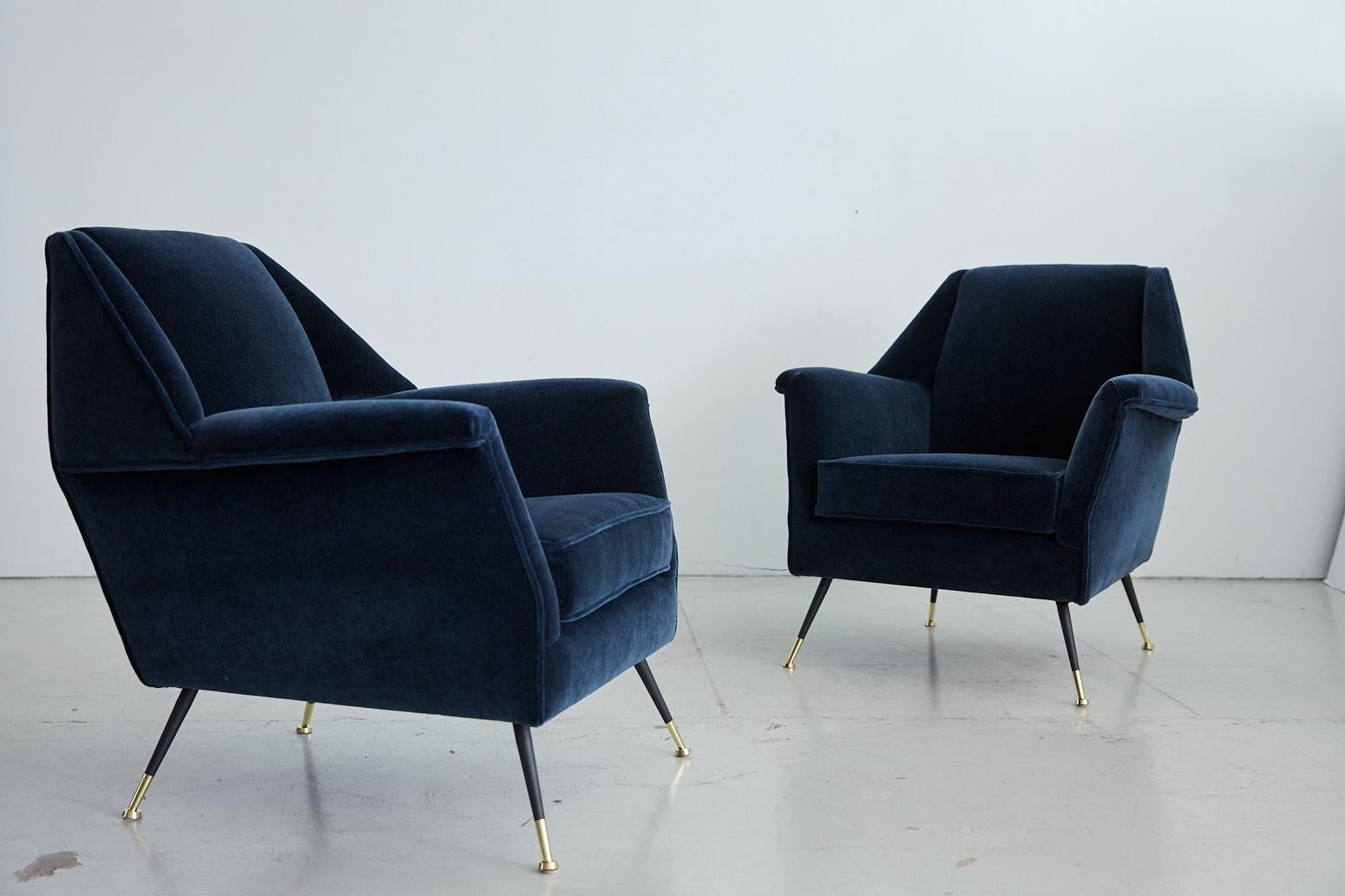 Great pair of large scaled Italian Gigi Radice club chairs with angular arms and back. Geometric shaped tapered back with iron and polished brass legs. Newly upholstered in a rich navy blue mohair fabric.
  
