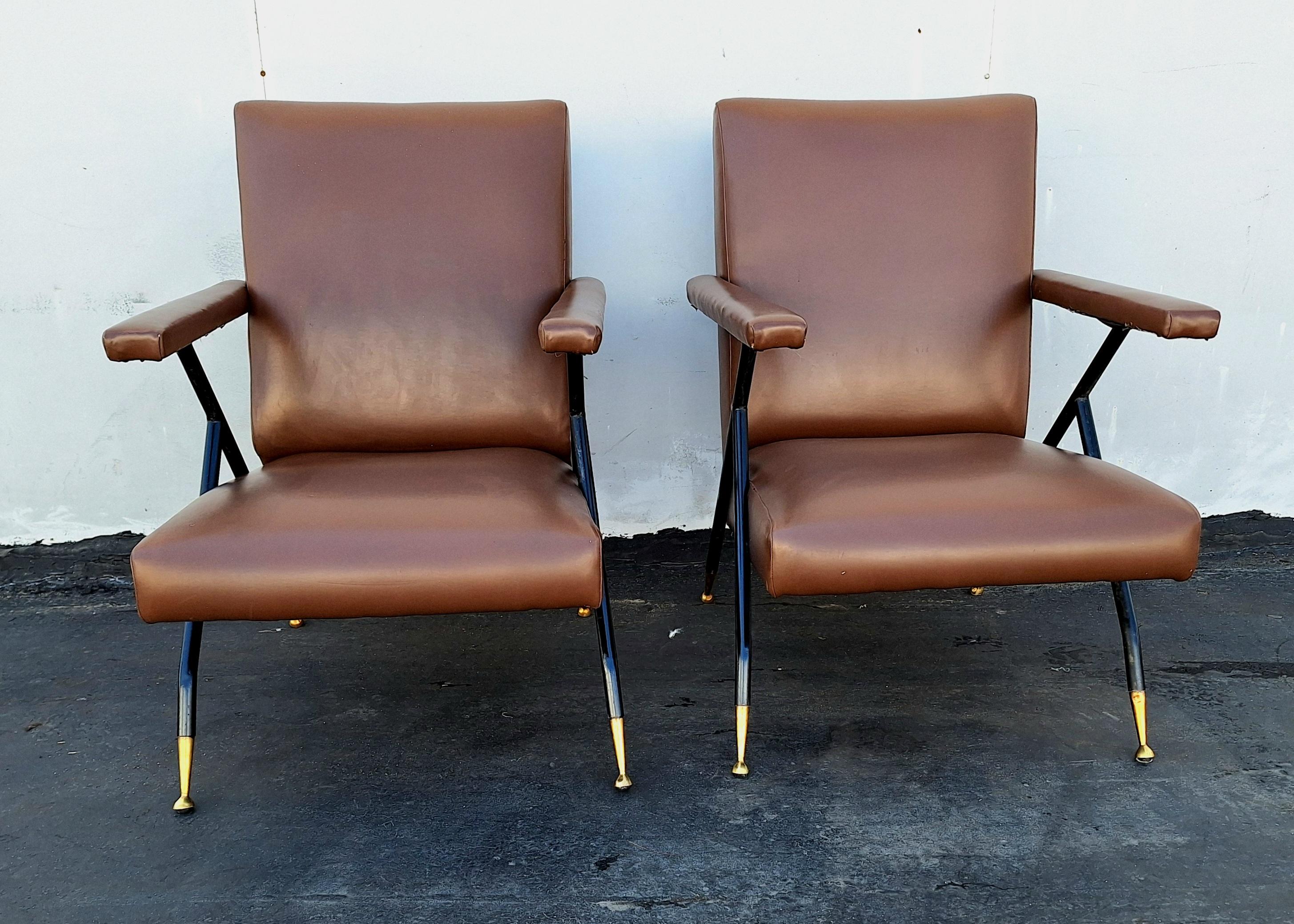 Italian mid century chairs ,metal frame  brass boots legs  vinyl upholstery in original condition .Chairs are comfortable and typical  mid century Italian design .  