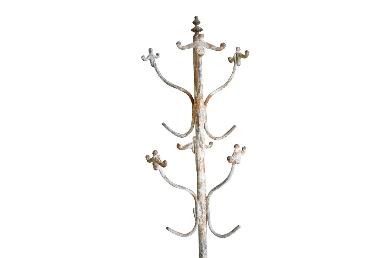A charming early 20th century Italian coat rack in painted metal. A wonderful accessory for any home, store or business.