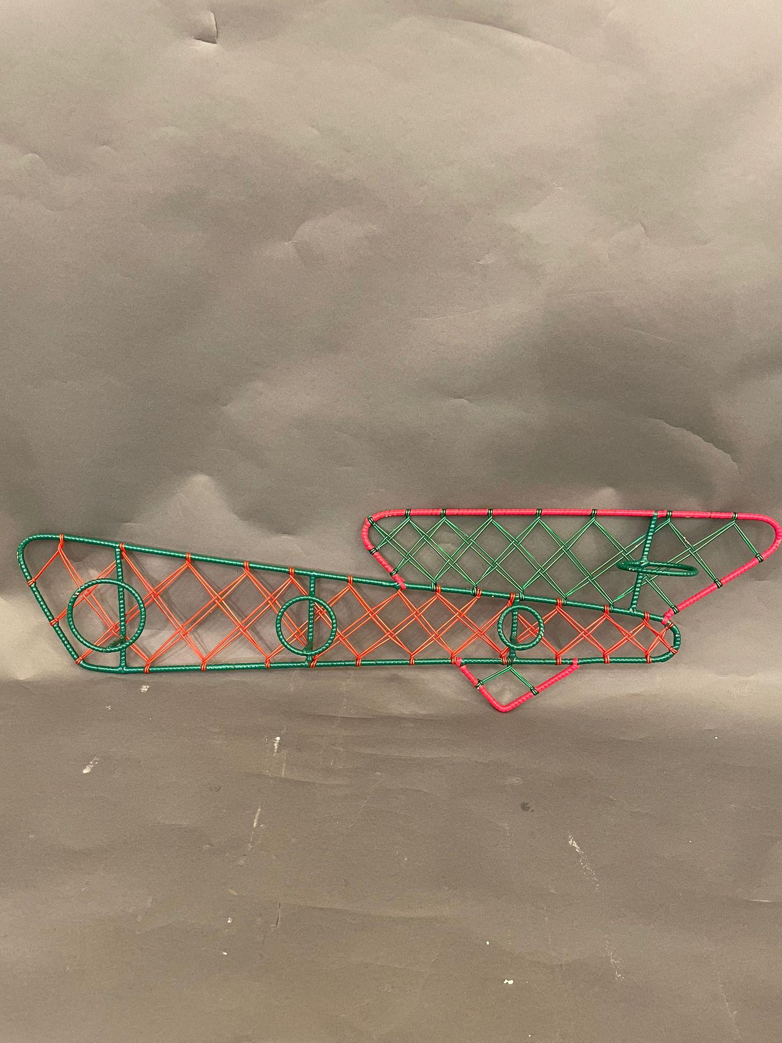 An original Italian coat rack in iron with green and red plastic decorations, circa 1950s.