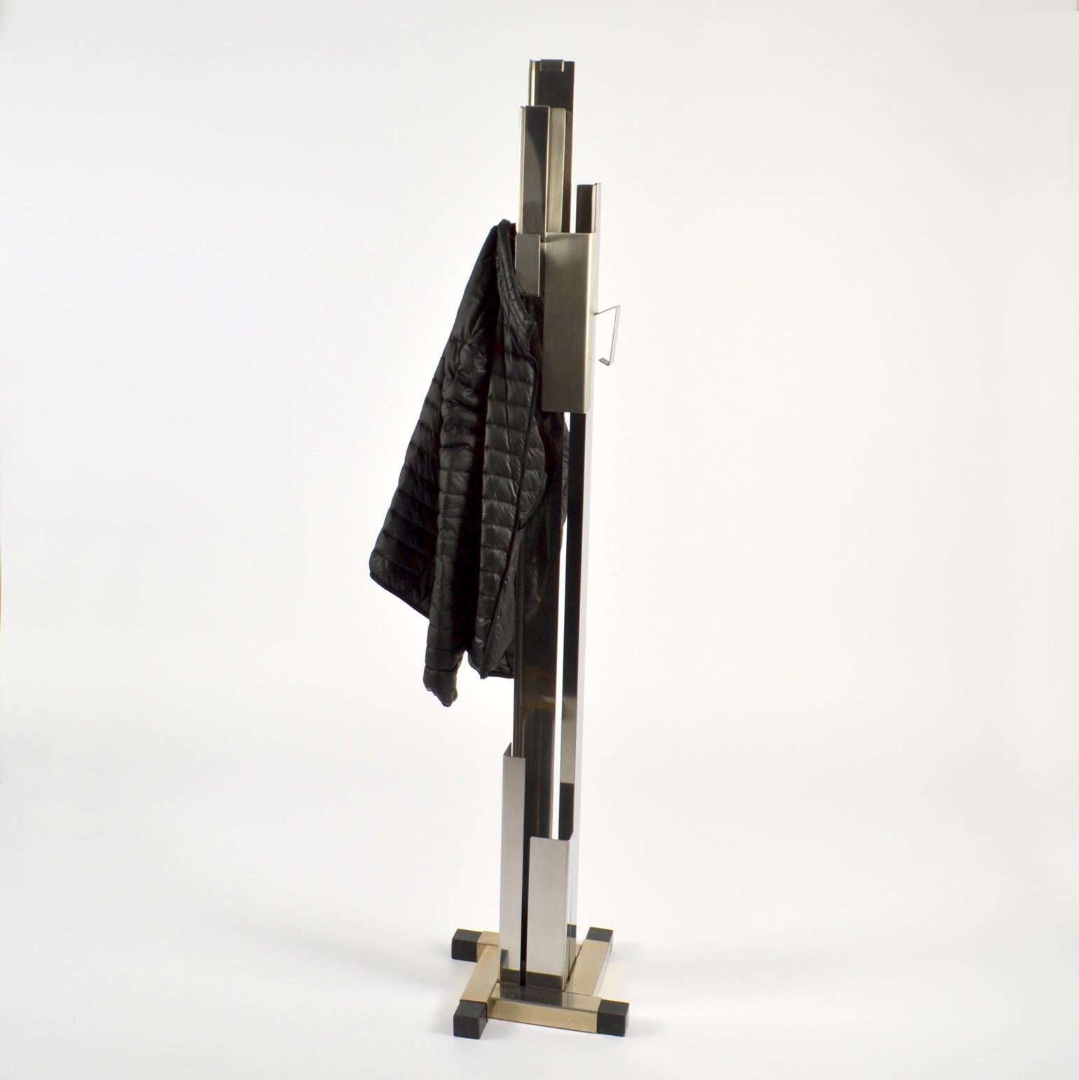 Sculptural Italian 1960s freestanding coat and umbrella stand is an eye-catching and functional object. It  is formed by folded stainless steel , partly brushed or polished, has four hooks attached on different sides. The base is extended with