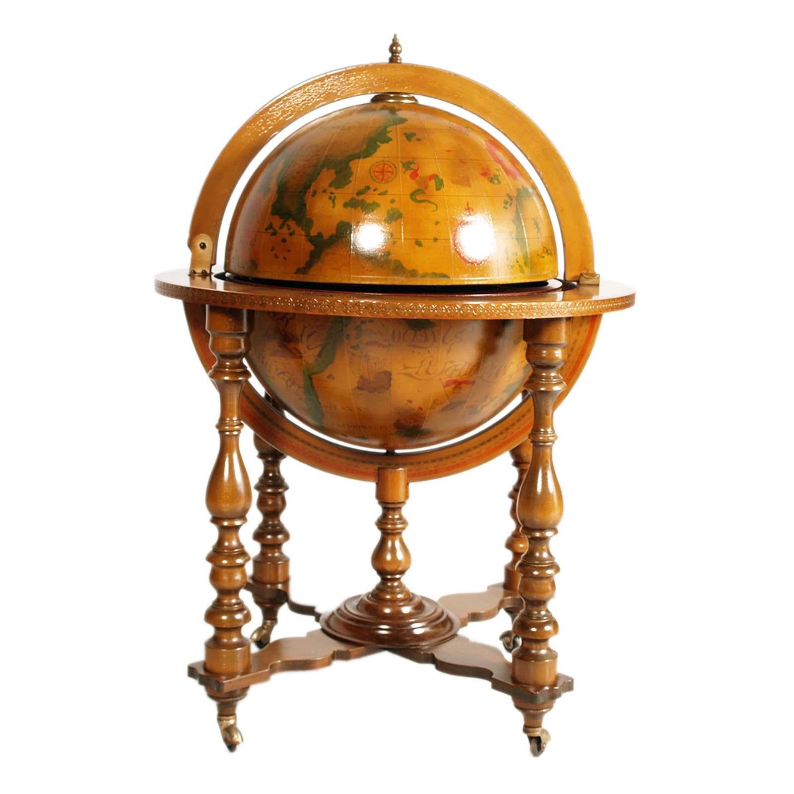 Italian 20th century on decorated world map cocktail bar cart. The globe rotates and is supported by a four-legged structure on wheels. The globe opens onto a compartment for bottles and glasses. The  equatorial ring and iteriors of the globe