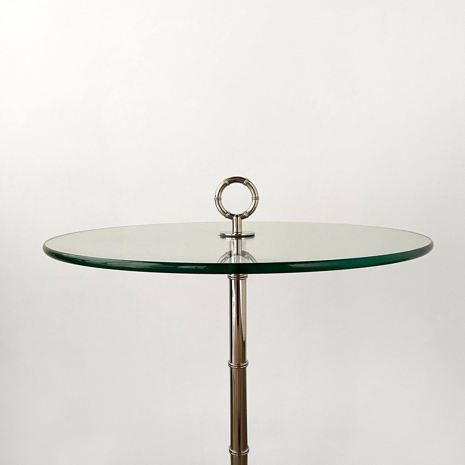 Italian cocktail table in the style of Cesare Lacca 
Floating glass top with heavy weight tripod base and loop detail
Glass has light surface markings from age and use
Beautiful and functional table.