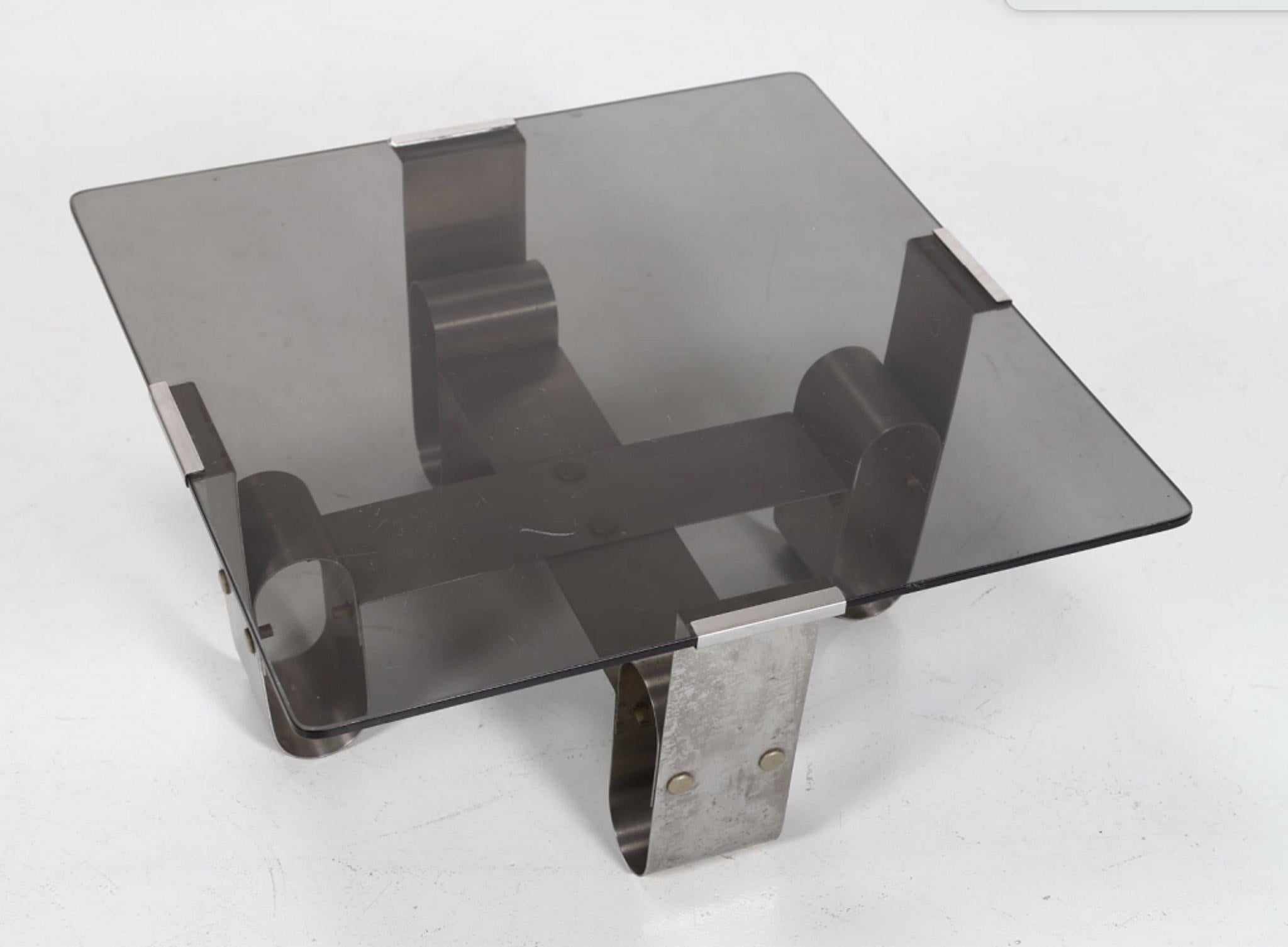 Italian coffee table is an original design work realized in the 1970s.

Original steel and glass.

Made in Italy.

Total dimensions: cm 60 x 28.5 x 60.

Very good conditions except for a minor scratch on the glass.