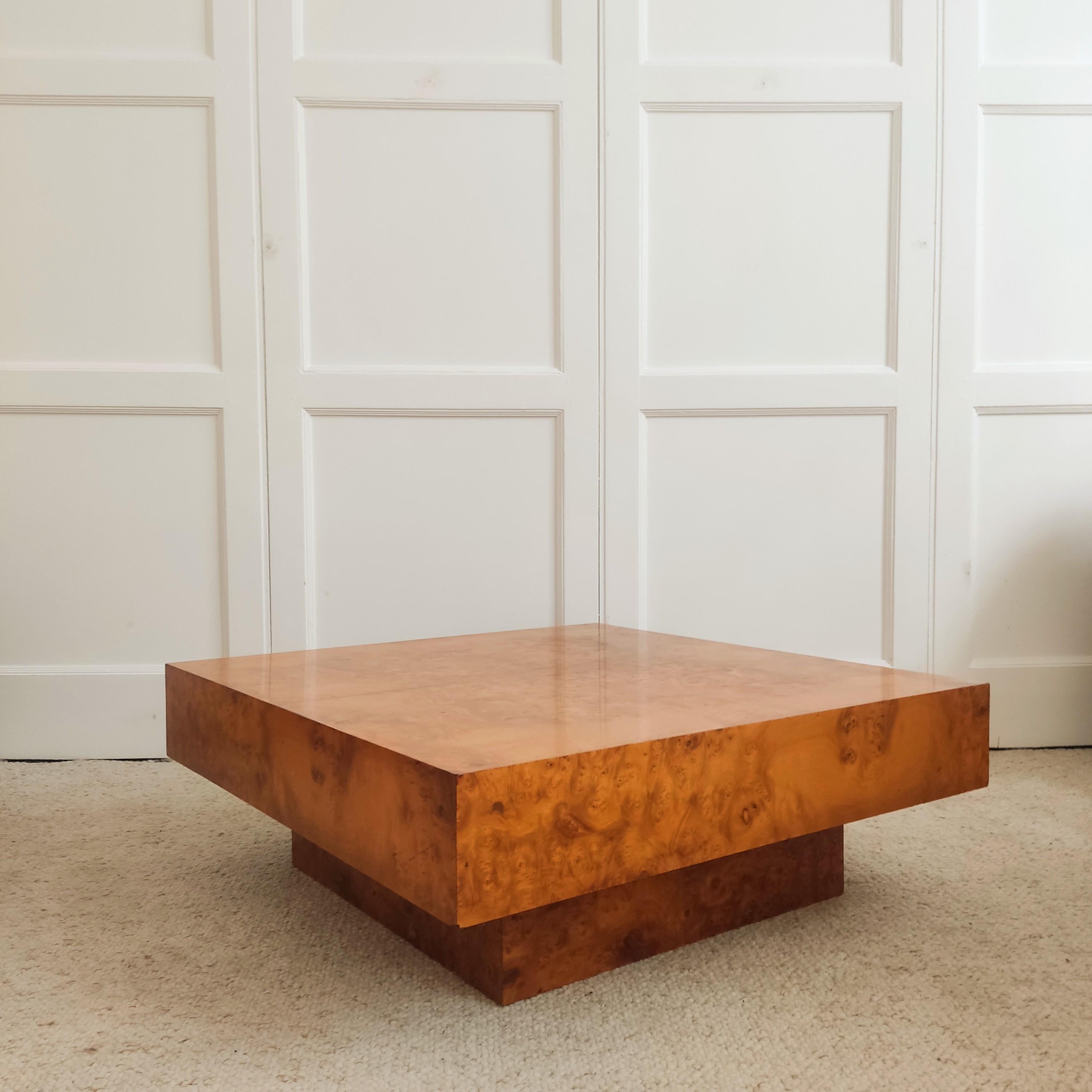 Italian coffee table from the 1970s - Radica.

Square in shape with a large top mounted on a square leg of the same height.
This typical 1970s table offers plenty of character with its burl wood veneer.
One slight flaw on the top (see