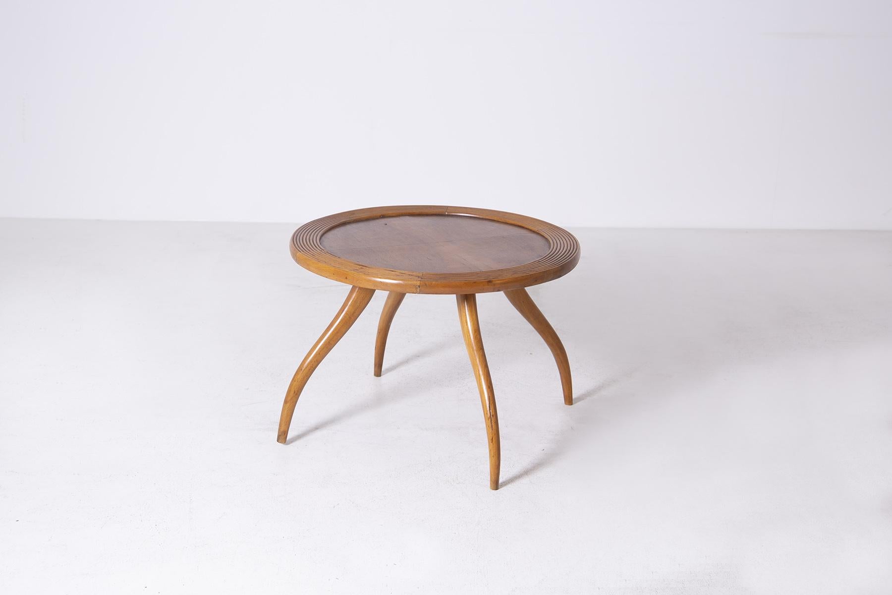 Refined wooden coffee table attributed to Osvaldo Borsani from the 1950s. Cherry wood. The table top is round and its peculiarity is its circumference made with grissinatura. In the centre we find the perfectly smooth top, made for placing various