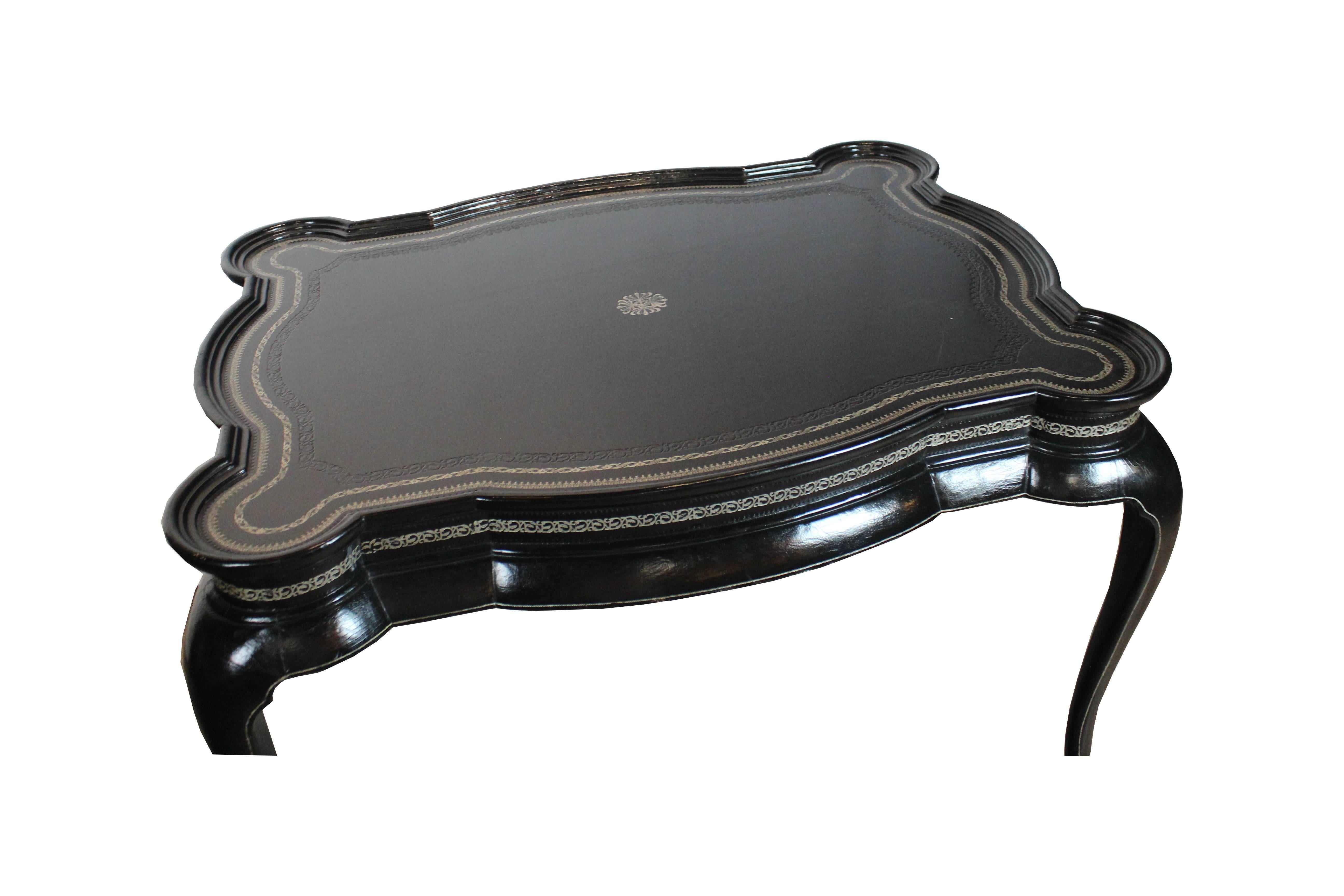 Black leather coffee table with Greek motif silver decoration on the edge.