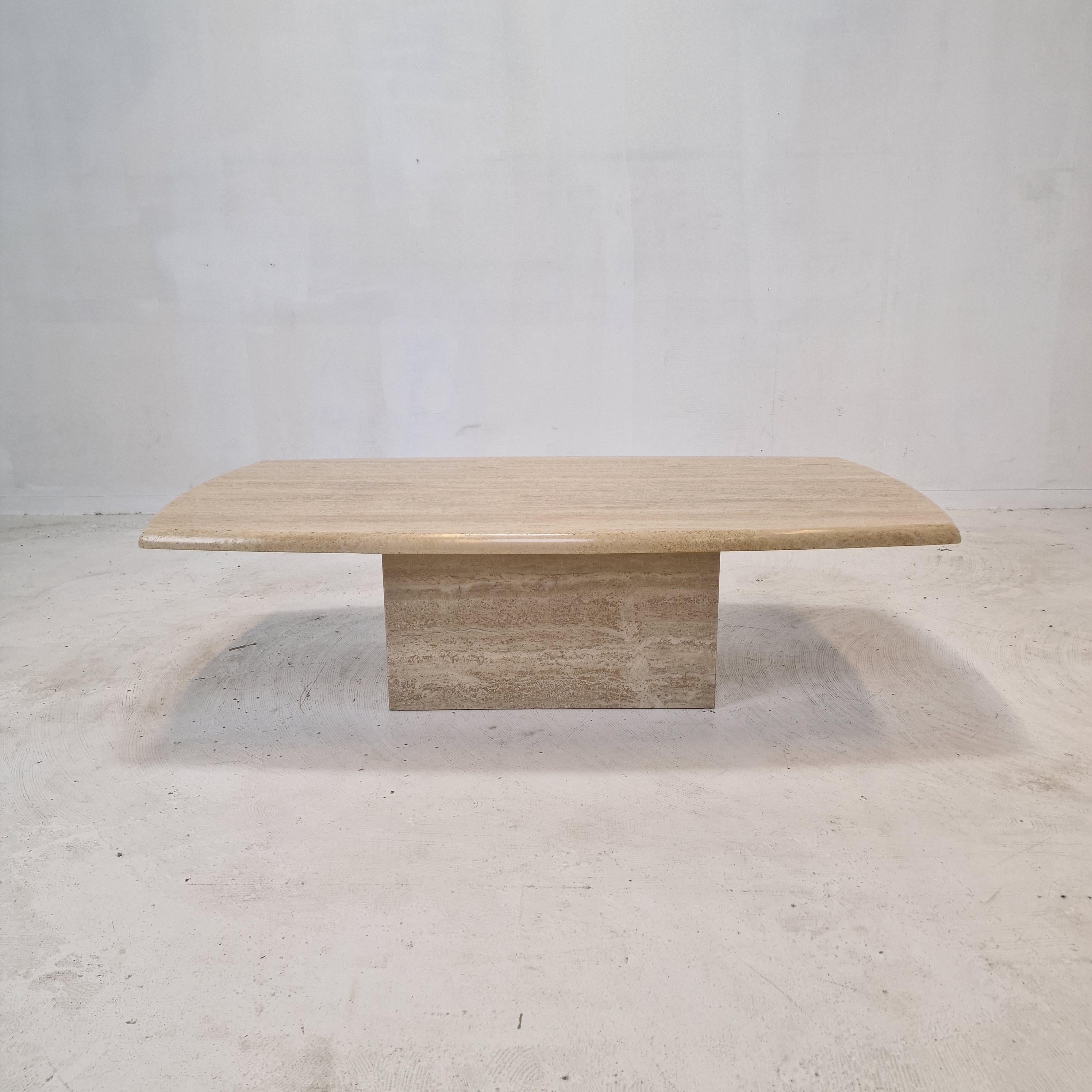 Very nice Italian coffee or side table handcrafted out of travertine, 1980s.

The rectangle top is rounded on the edge. 
It is made of beautiful travertine.
Please take notice of the very nice patterns.

It has the normal traces of use, see