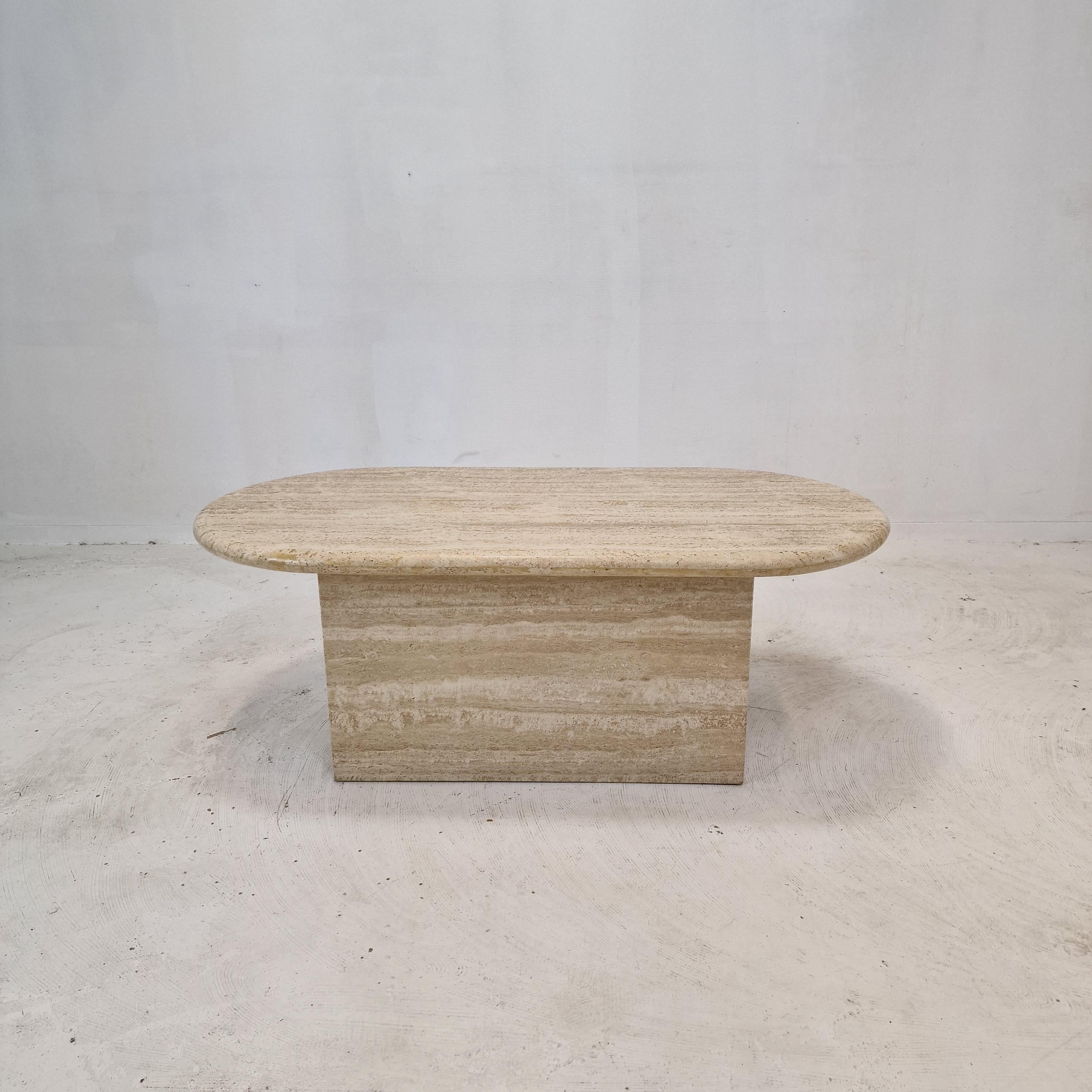 Very nice Italian coffee or side table handcrafted out of travertine, 1980s. 

The top is rounded on the edge. 
It is made of beautiful travertine. 
Please take notice of the very nice patterns. 

It has the normal traces of use, see the