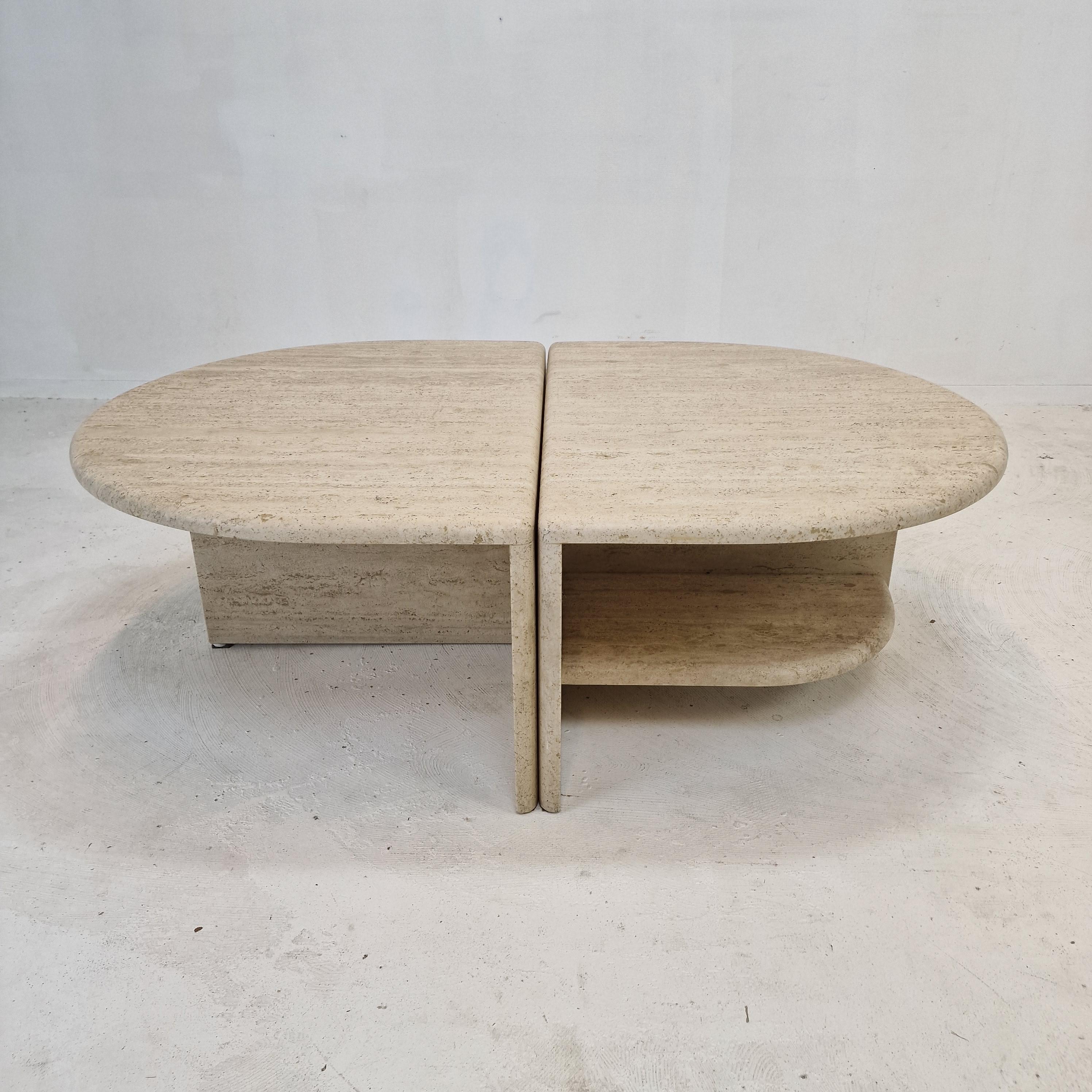Very nice set of 2 Italian coffee tables handcrafted out of travertine.

The oval shaped top is rounded on the edge. 
It is made of beautiful travertine.
Please take notice of the very nice patterns. 

It has the normal traces of use, see the