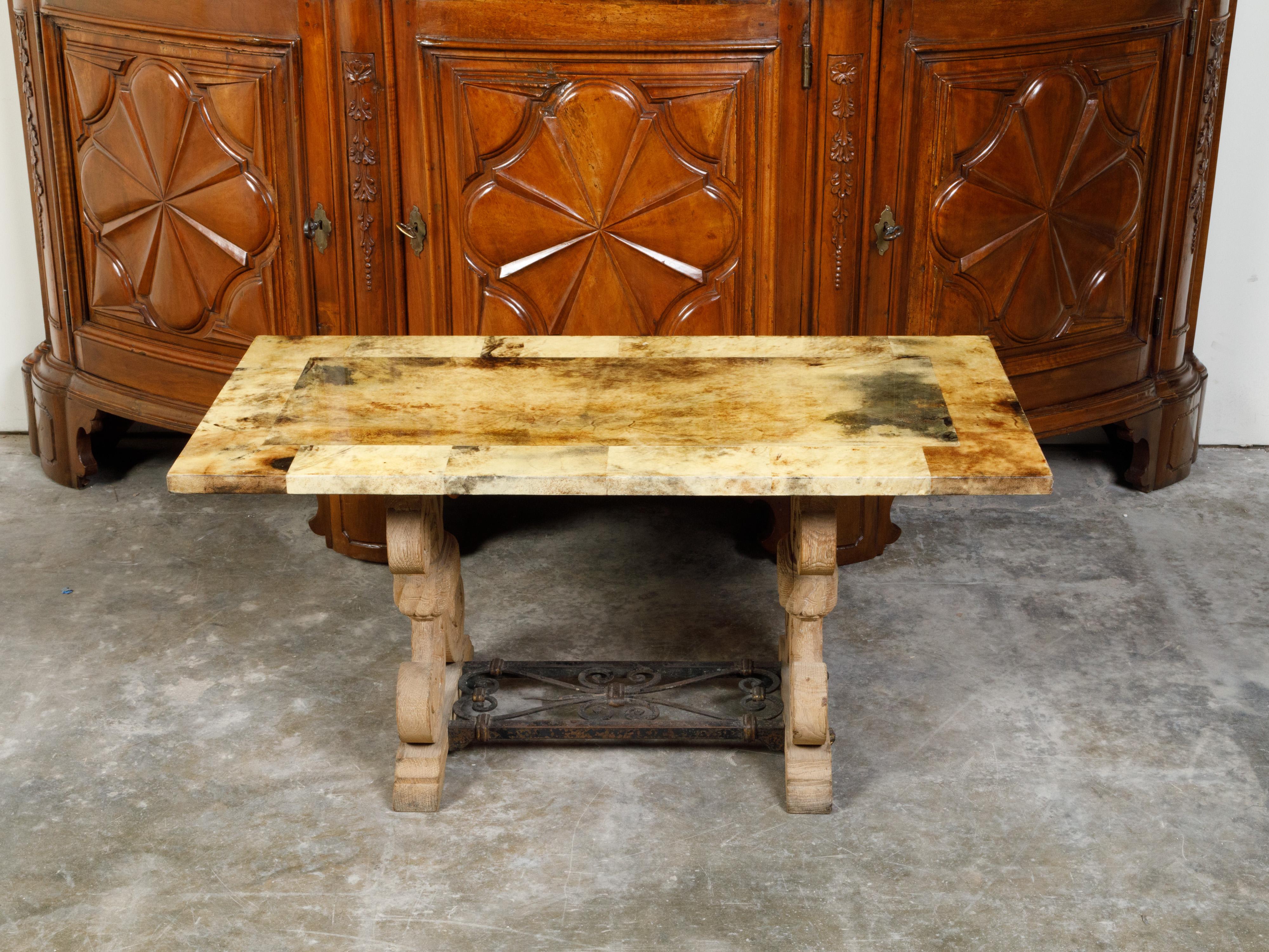 An Italian coffee table made of a 19th century bleached oak base and 20th century vellum top. Created in Italy, this coffee table features a rectangular vellum covered top sitting above a double X-form bleached oak base with iron stretcher. Boasting