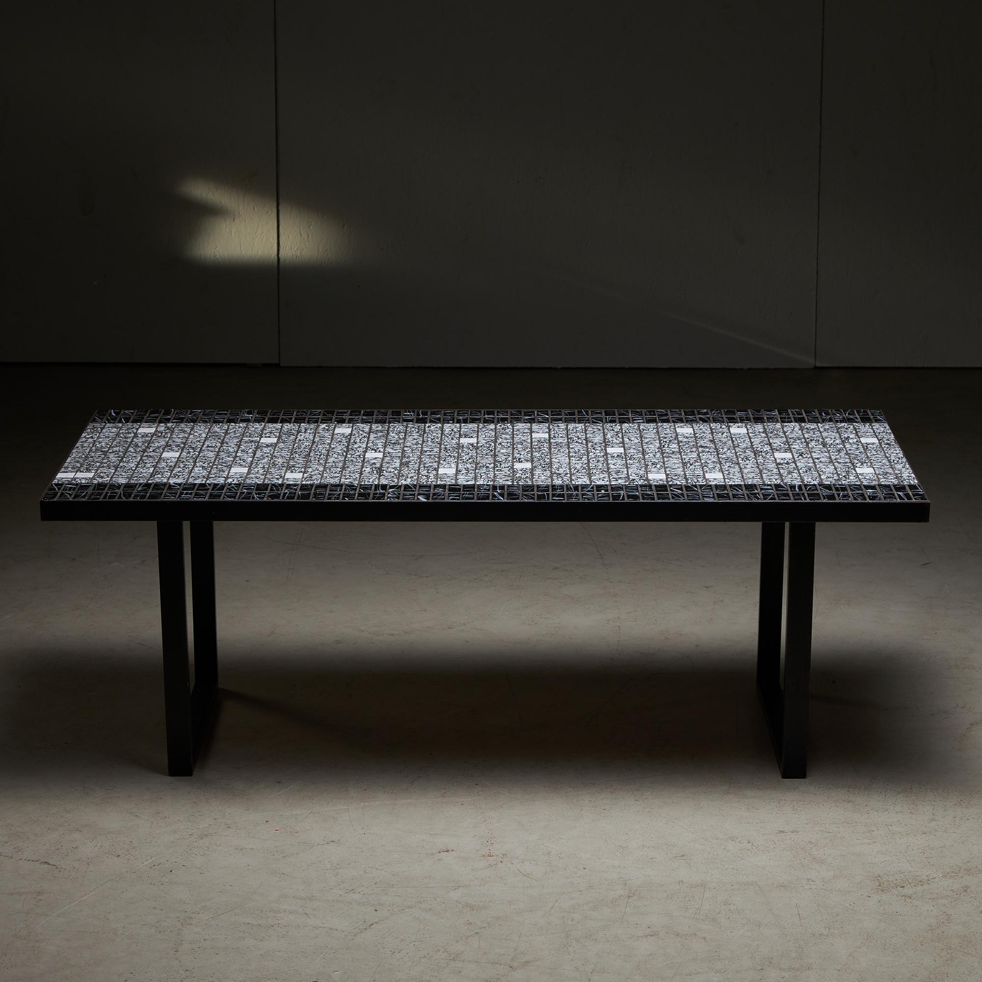 A piece of Italian design from the vibrant 1980s: a coffee table of pure style and sophistication. Set upon a sleek, sturdy metal frame, this stunning table is adorned with black and white mosaic tiles made of ceramic, promising to be the focal