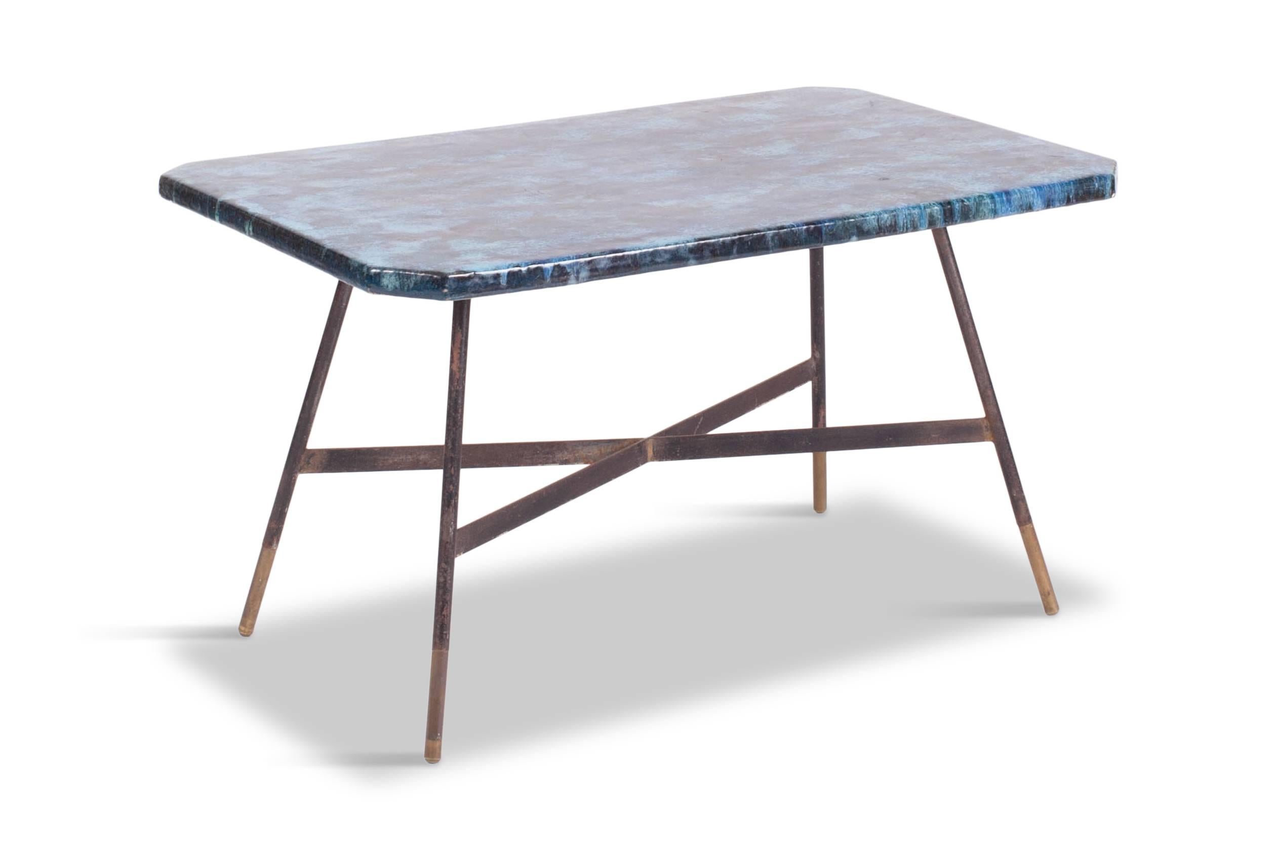 Decorative Italian coffee table signed ACMA Italy on the bottom.
The enamel tabletop is provided with a cloud like illustration in a variety of blue tones, done in porcelain glaze.

The black lacquered steel frame is finished with elegant brass foot