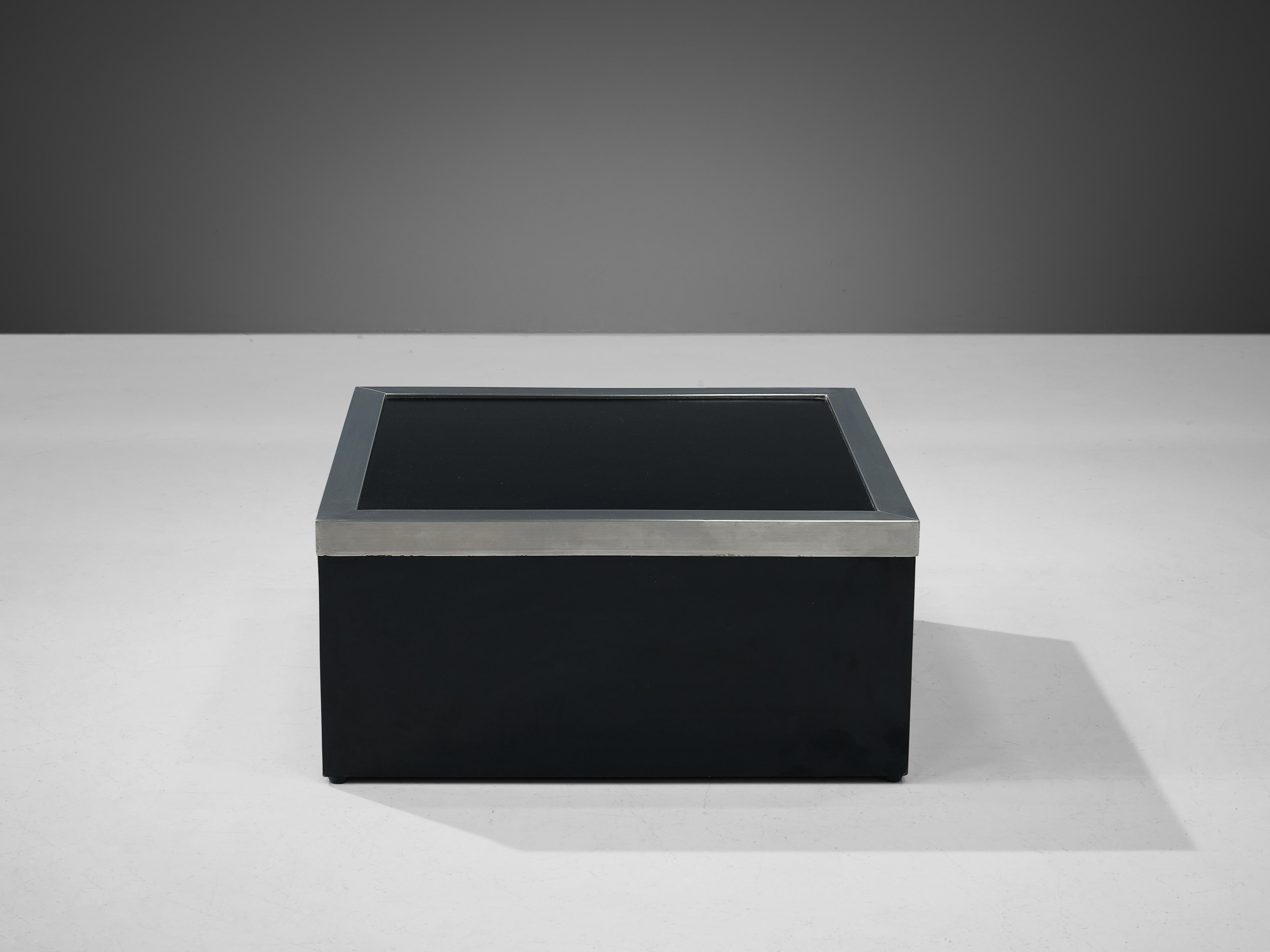 Coffee table, aluminum, lacquered wood, Italy, 1970s

This black coffee table was made in the 1970s in Italy. The squared top has a aluminum side border, emphasizing the shape of the design. The top is supported by a sturdy, low base, giving it a