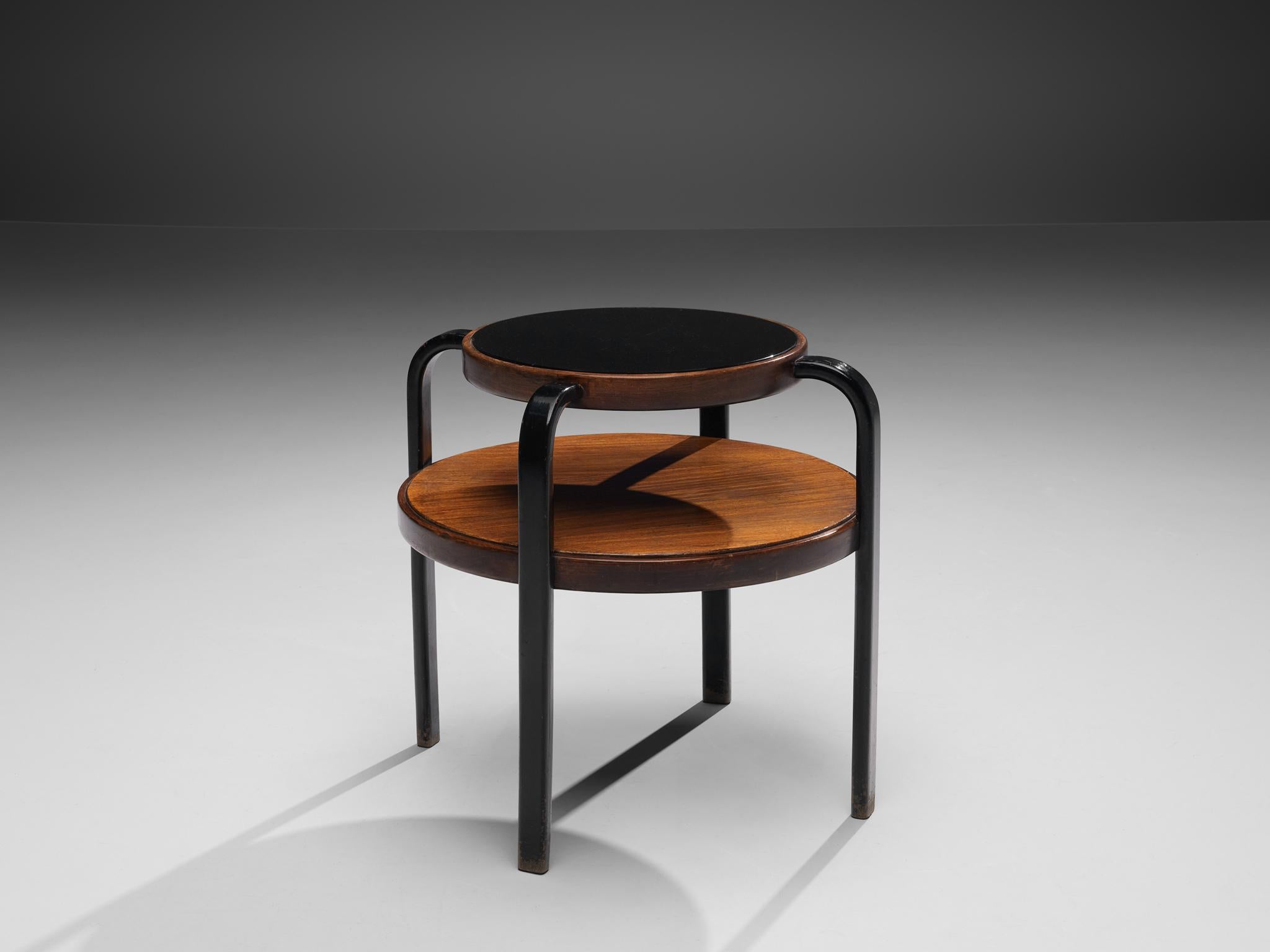 Coffee table, walnut, wood, glass, Italy 1960s

This side table is structured in two levels by means of two round tops varying in size. Four black curved legs run upwards, holding the big tray at the sides and the smaller tray with a black colored