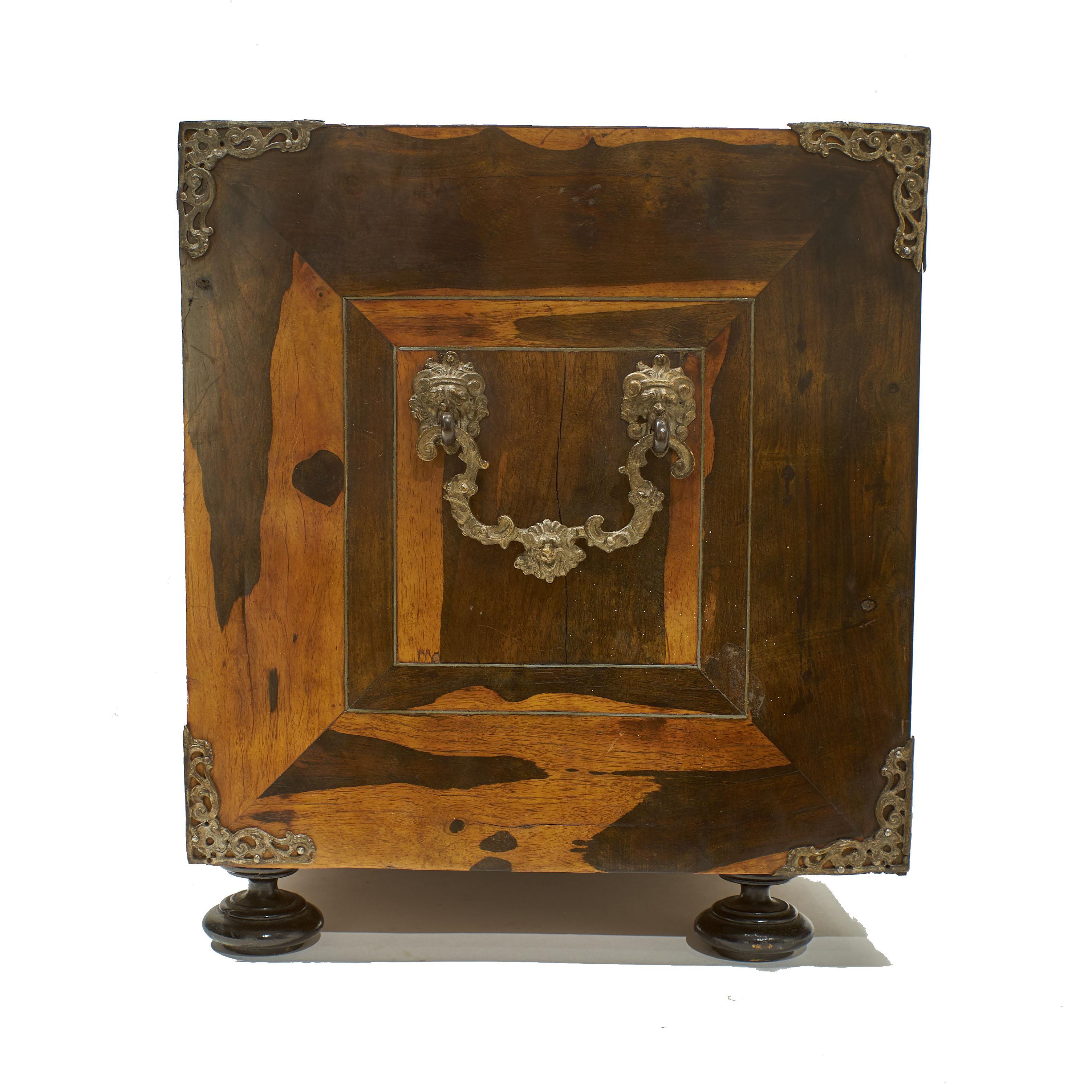 A 17th-18th century North Italian inlaid table-cabinet clad coromandel veneers and
embellished with panels of bone marquetry of classical figures framed by strings of pewter
inlay. The rectangular cabinet having decorative pierced corner mounts