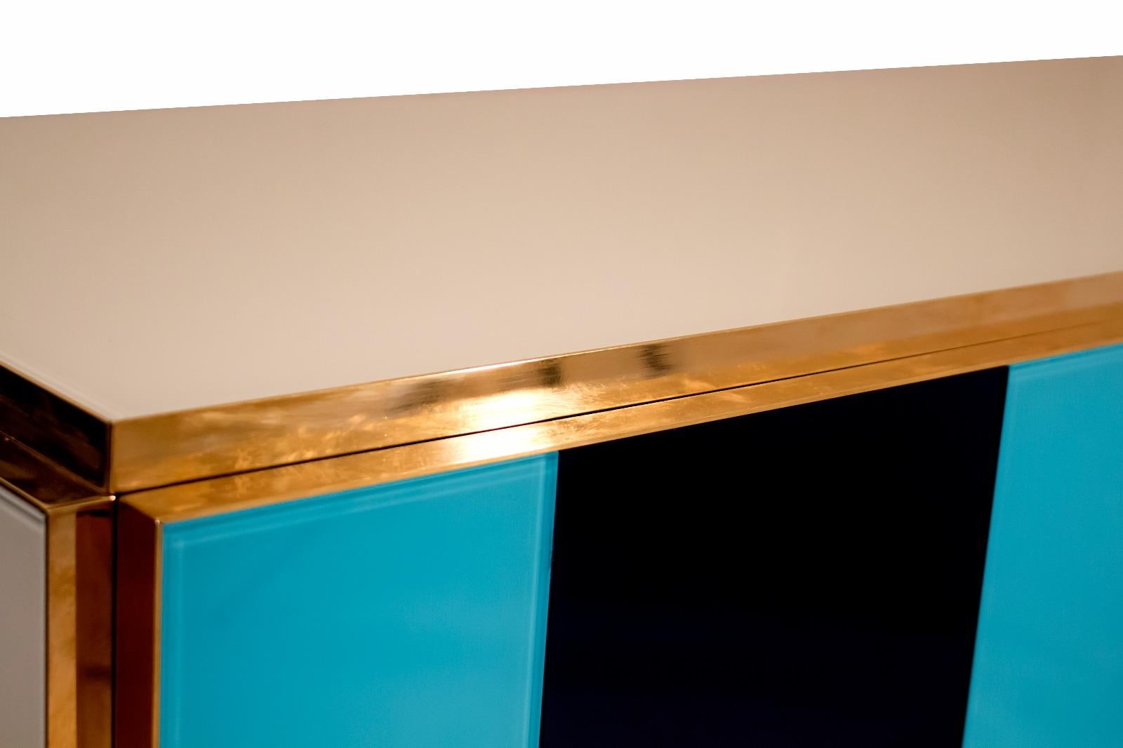 Colored glass sideboard

Brass base and details

Postmodern mix of colors

Contemporary,

Italy.