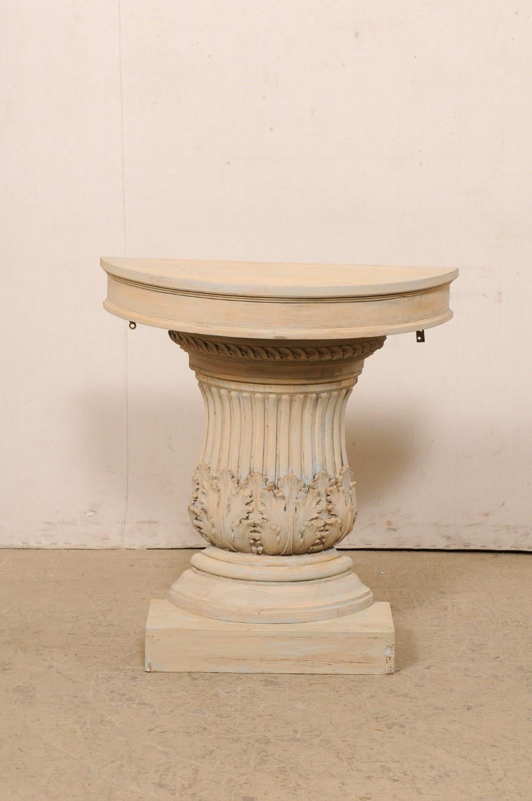 An Italian carved-wood half column demi-lune table. This vintage wall console from Italy features a half-round shaped (demi) top, above a curvaceous flute and acanthus-carved column body, with thick and rounded molding and raised upon a rectangular