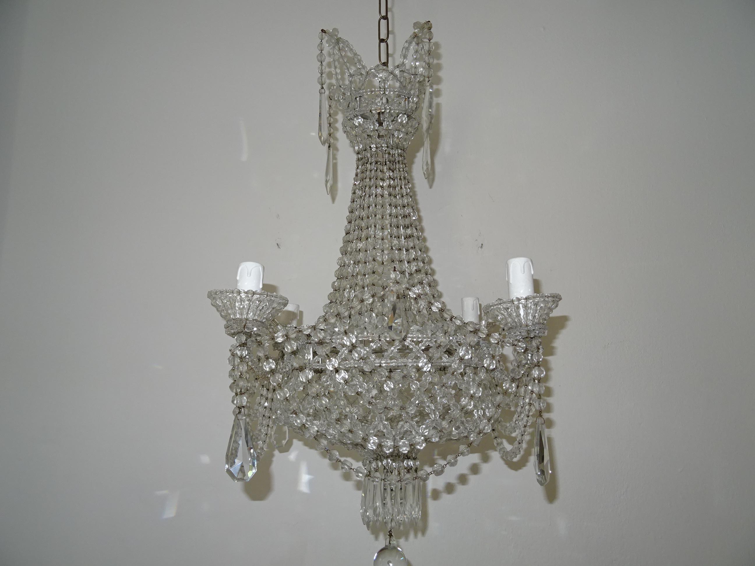 Housing four lights in beaded cups. Completely beaded with a beaded lace bottom. Adorning crystal prisms on top and in bottom. This chandelier has two widths... 19.5 and 14 inches. Adding another 17 inches of original chain and canopy. Will be
