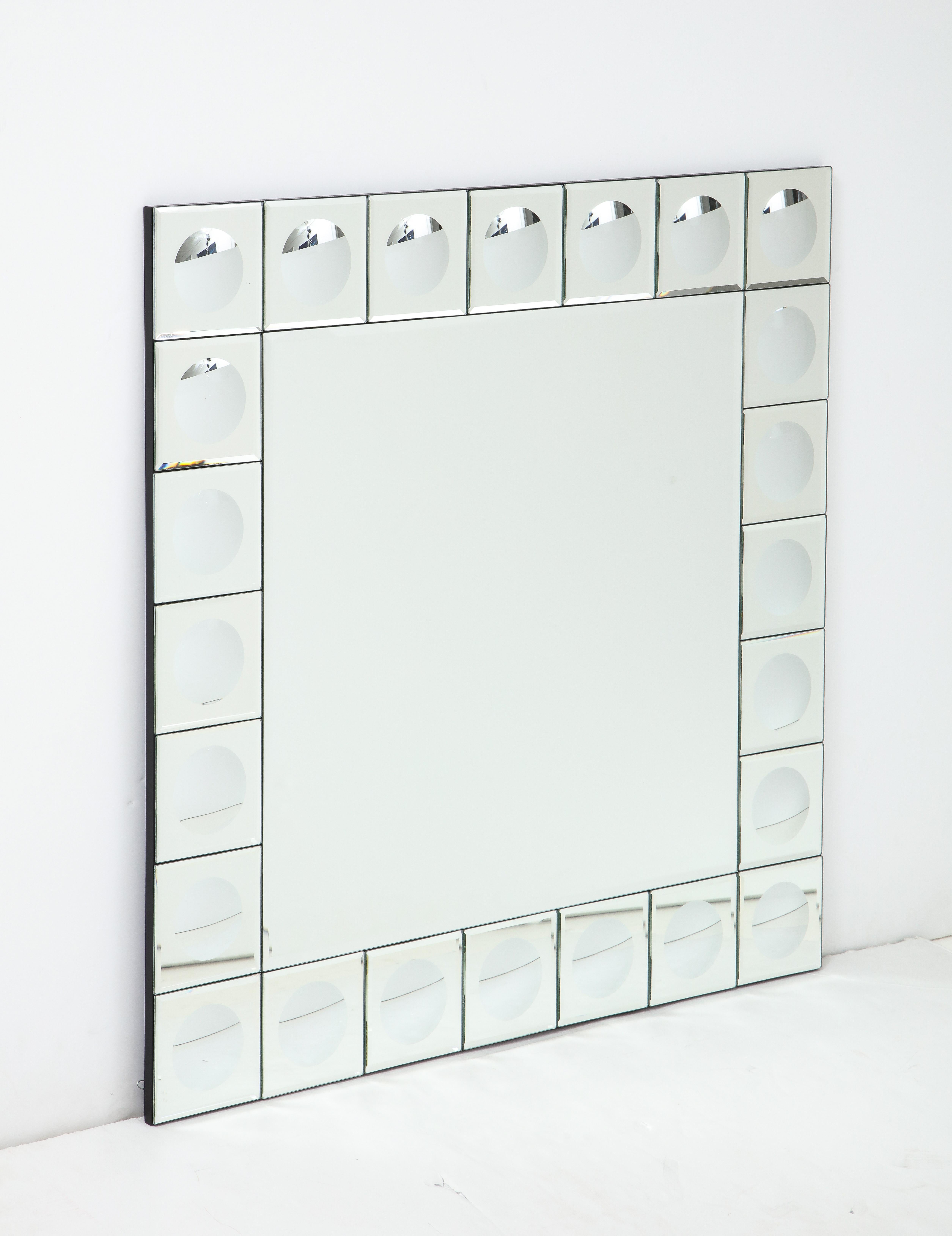 Modernist Italian mirror surrounded by concave dot mirror panels.