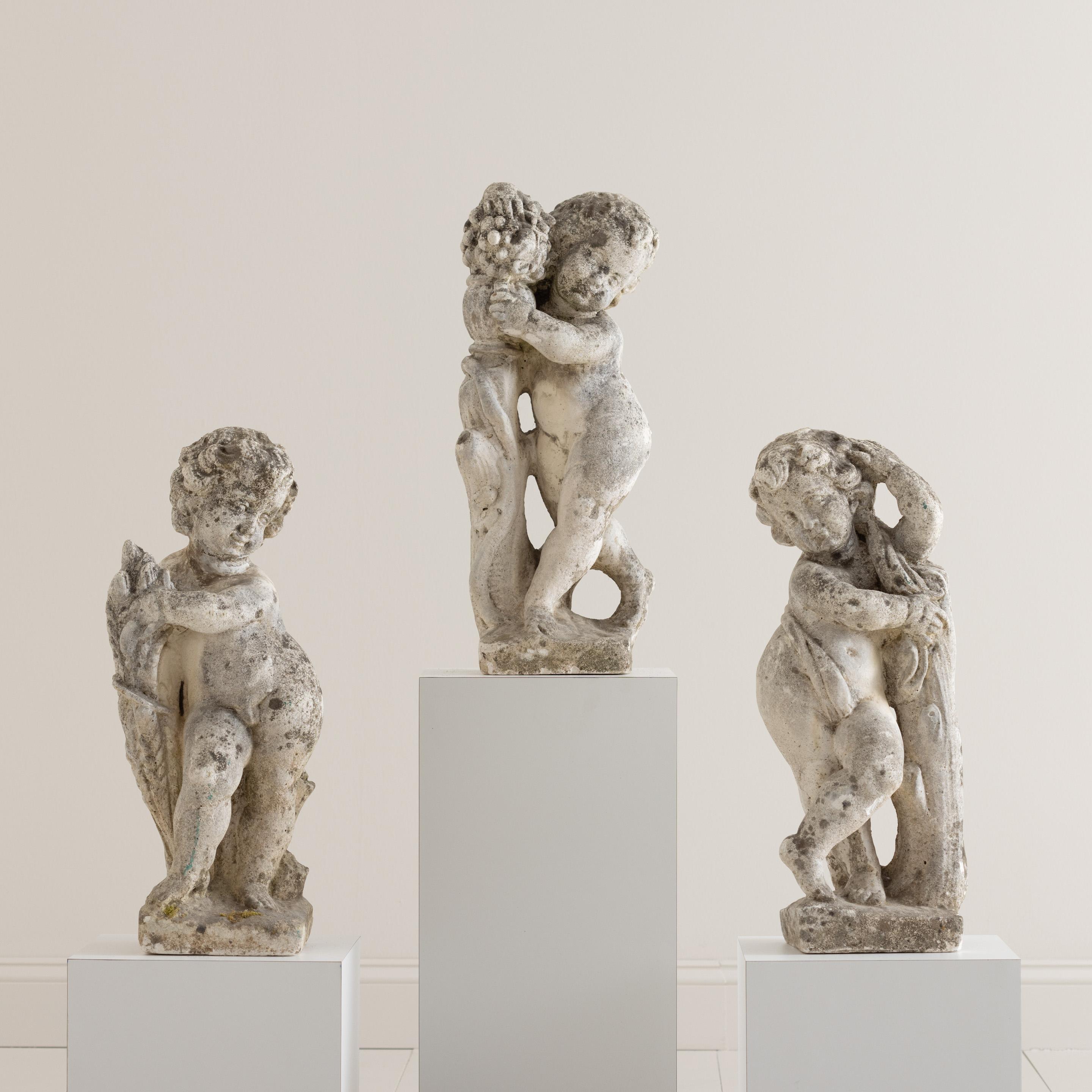 Sold separately.  Center featured cherub is sold. Early 20th century concrete Italian garden statues of cherubs /putti figures, c. 1920. These charming, angelic statues are suitable for outdoor use. 


We offer expedited, fully-insured, custom