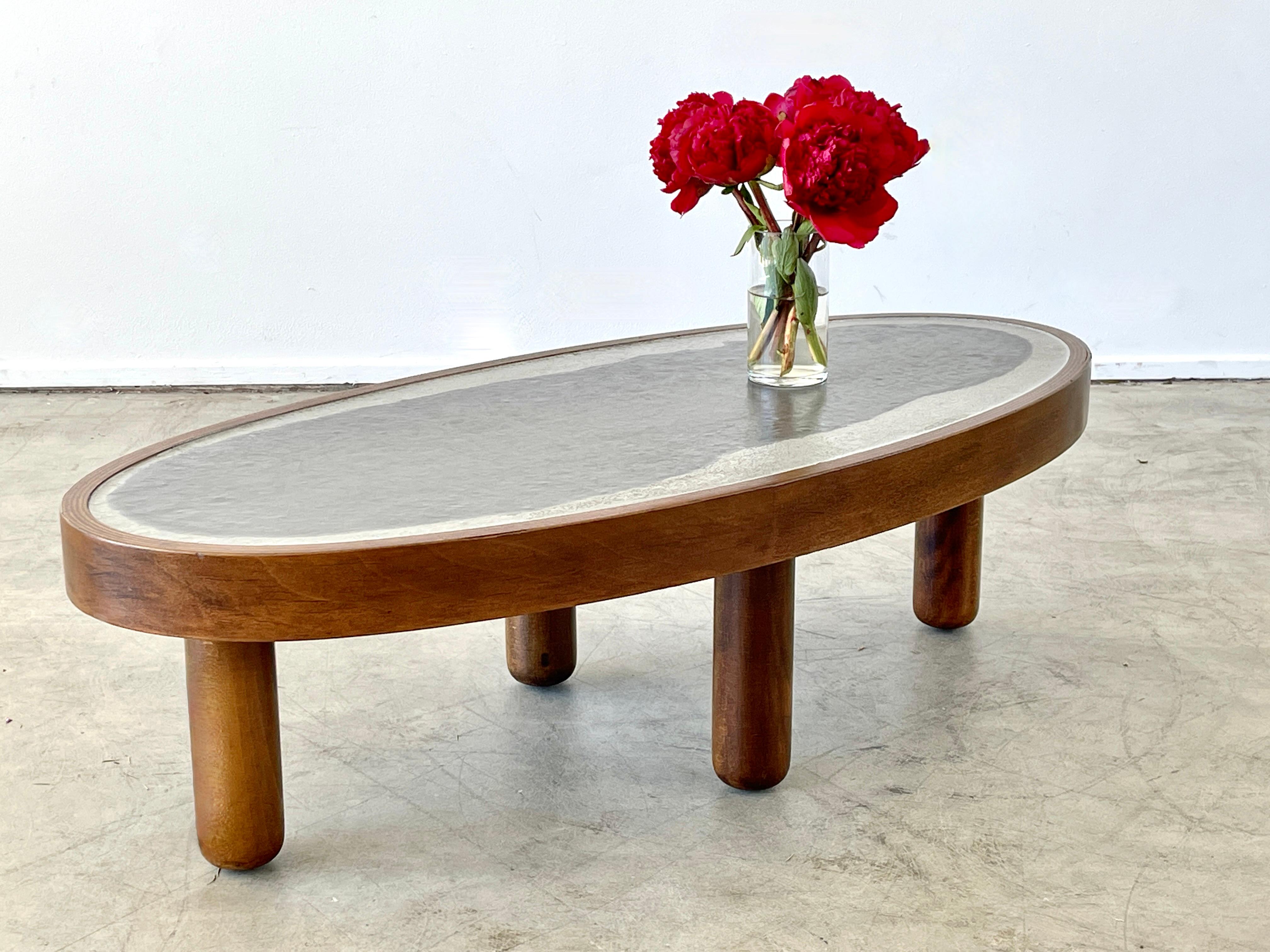 Unique Italian oval coffee table with two tone concrete top and solid wood legs. 
Gorgeous piece. 
Italy, circa 1960's.
