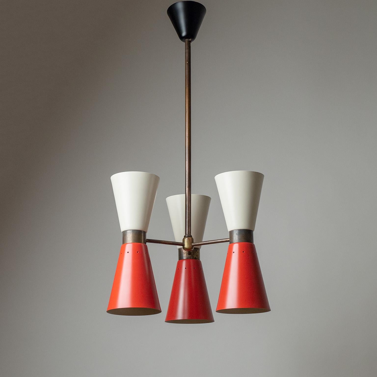 Italian cone chandelier from the 1950s. Brass structure with three arms, each with two lacquered cones, professionally repainted in their original colors. Each cone is equipped with a brass and ceramic E27 socket providing simultaneous down- and