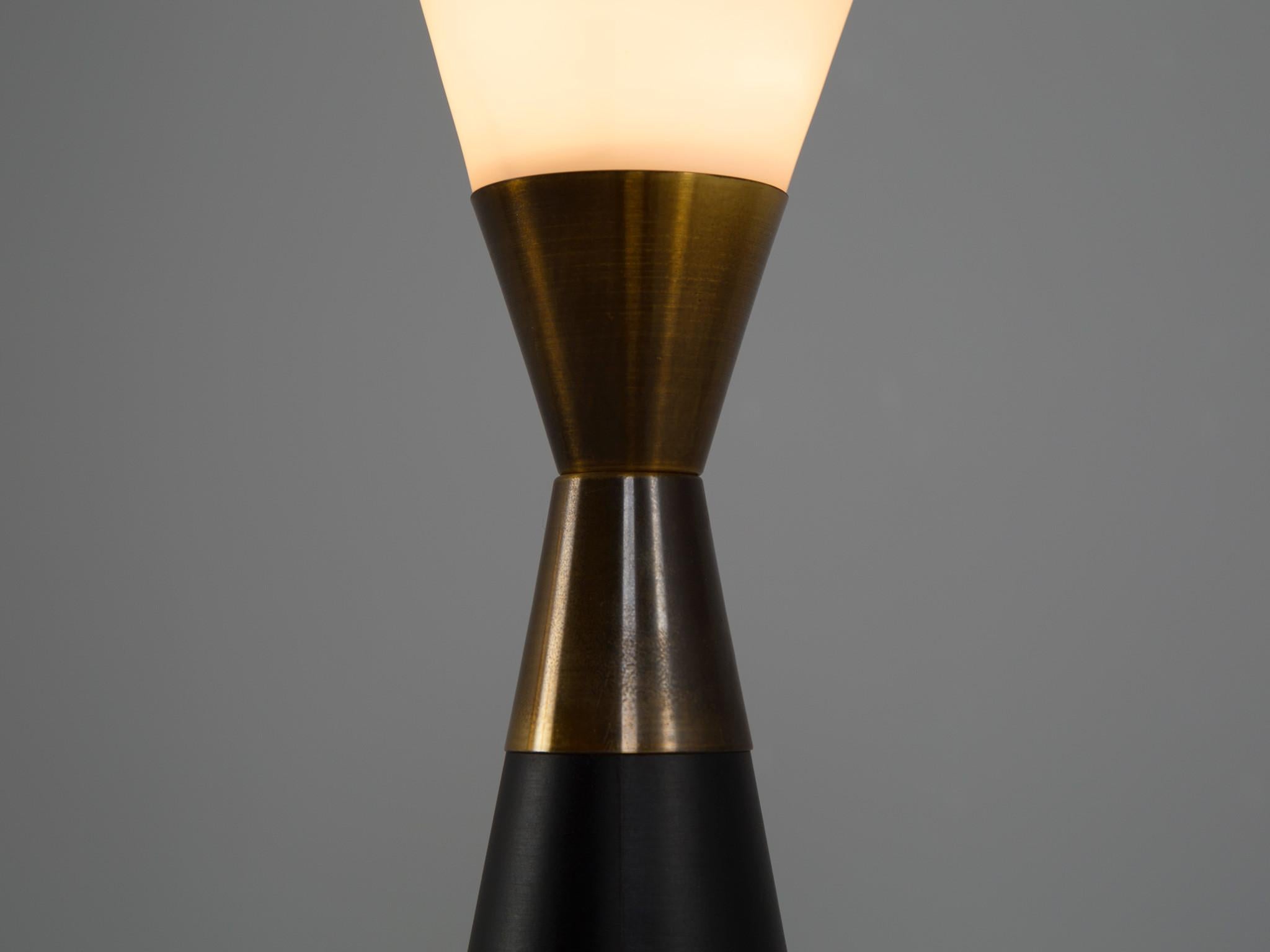 Table lamp, glass, brass, Italy, 1961

Very sculptural table lamp made out of opaline glass and brass. This unique shaped lamp is not only beautiful due to its form. Moreover, it is stunning thanks to the combination of white, opaline glass, the