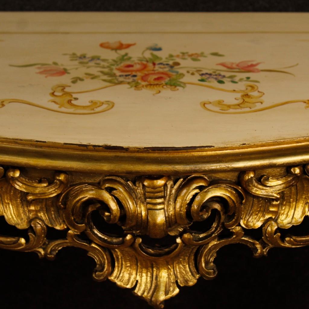 Italian console from 20th century. Furniture in richly carved, lacquered, gilded and painted wood with floral decorations. Ideal console for a living room or salon, of great decoration. Table with four legs of good stability. It has some small drops