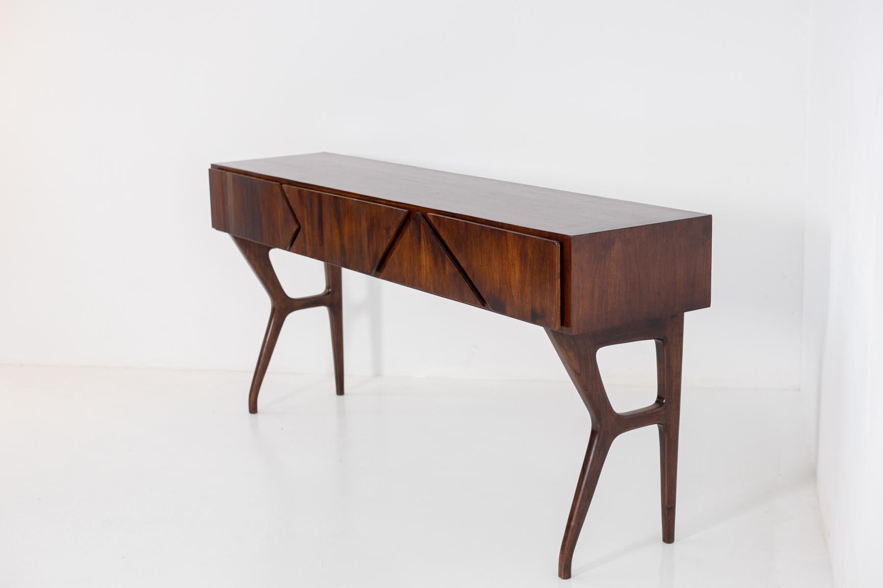 Important and large console attributed to the Bolognese architect and designer Melchiorre Bega, 1950s. The console is made entirely of walnut wood. The elongated rectangular top, embellished with a beautiful tactile grain and precise craftsmanship,