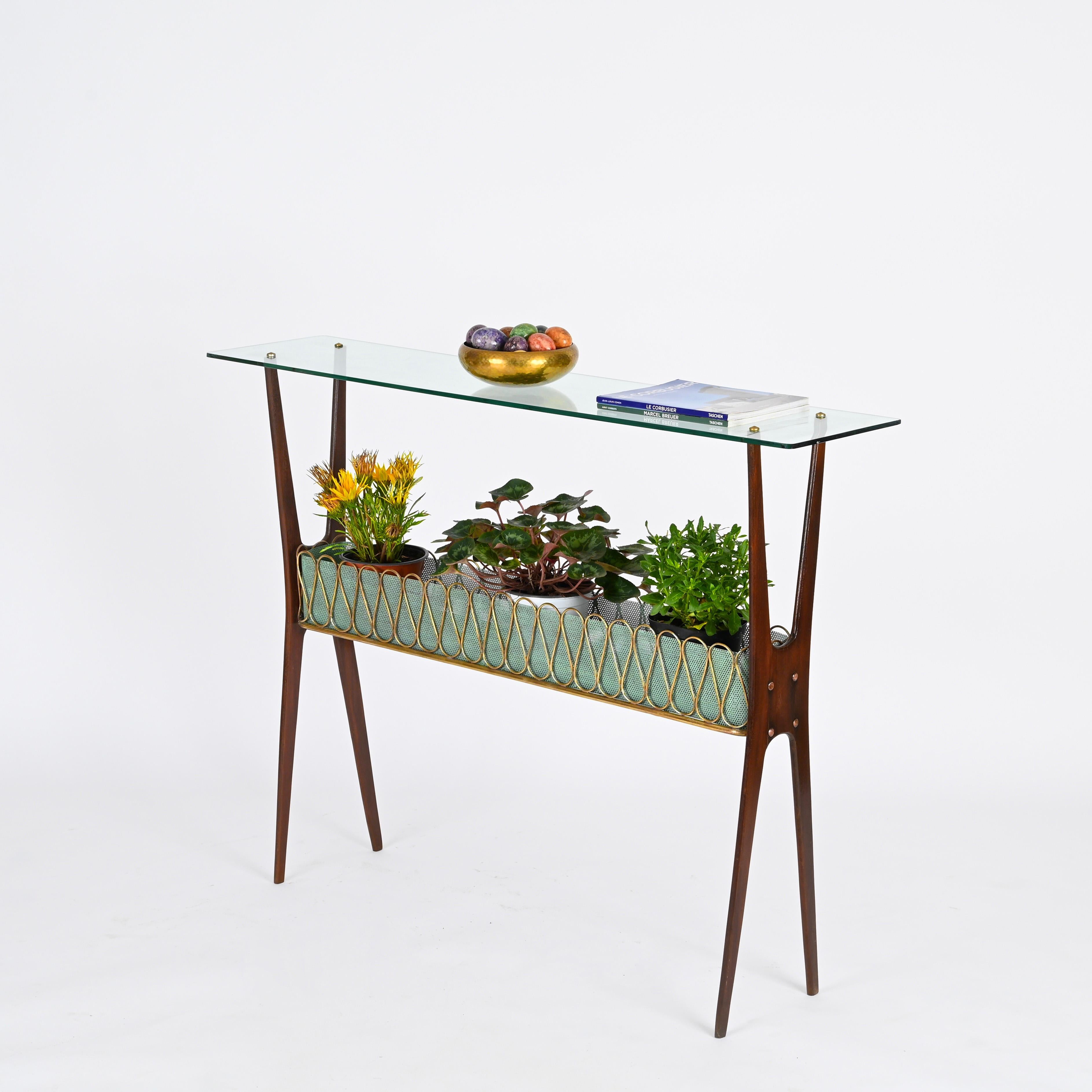 Incredibly elegant and unique console table in walnut, brass and enameled perforated metal with crystal glass top. This stunning piece was designed by Cesare Lacca and produced in Italy during the 1950s.

Fully original and in amazing condition.