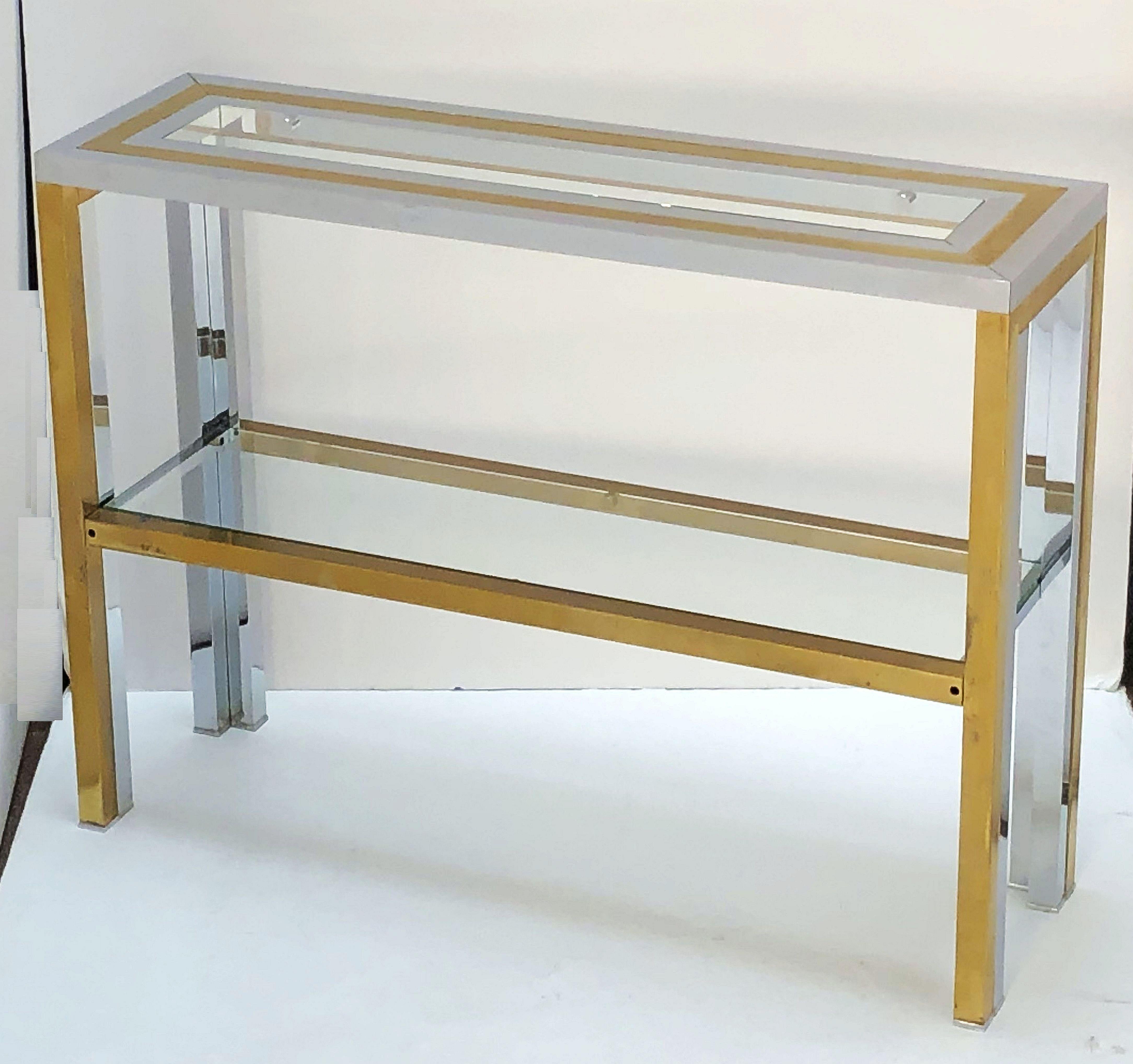 A fine Italian rectangular two-tiered console table of stylish brass and chrome by the celebrated modern designer, Renato Zevi, featuring a top with inset glass over four legs with lower shelf of inset glass.