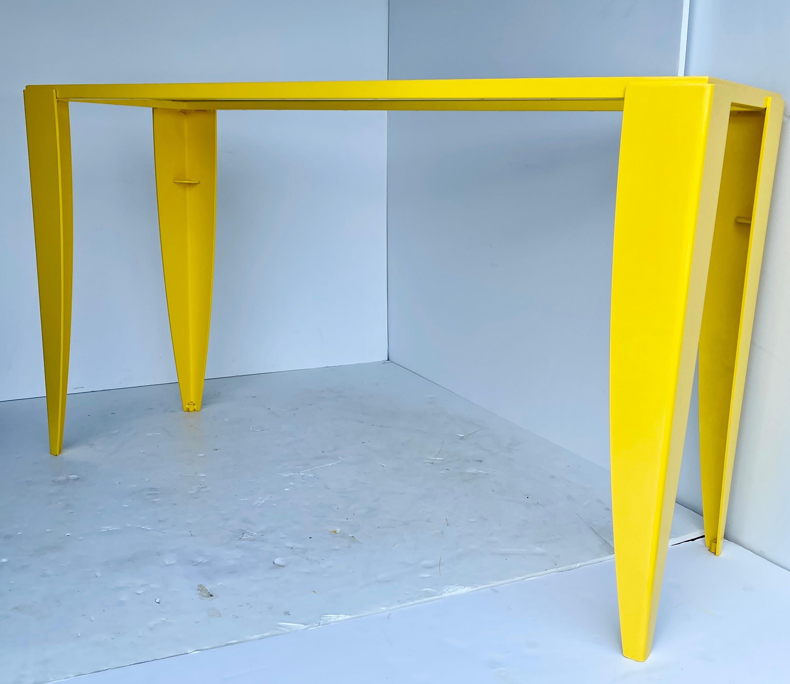 Mid-Century Modern powder coated bright sunshine yellow console table with glass top.
This bold Italian steel console table is bright as sunshine. The handcrafted glass top has horizontal steel striping, adding another point of interest to this