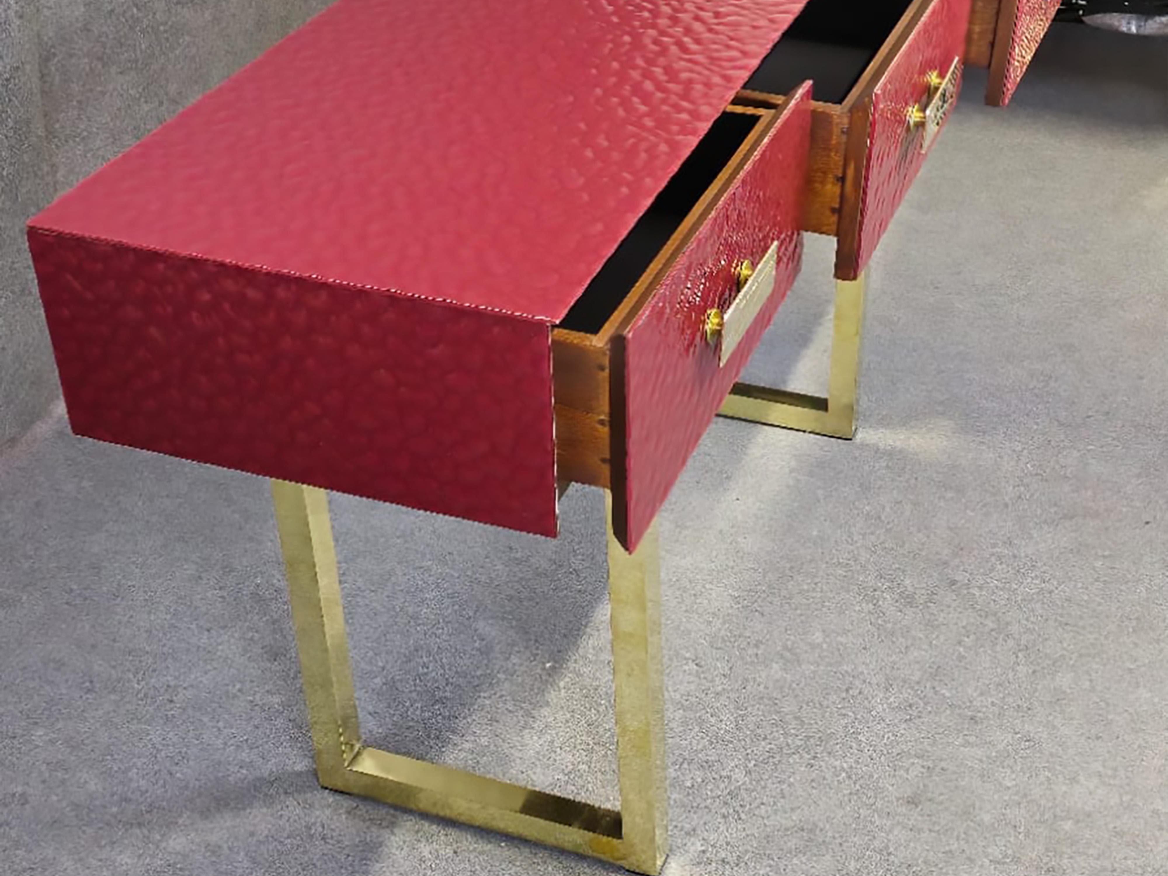This refined Italian console table features a beautifully beveled red Murano glass top, complemented by three functional drawers upholstered in black velvet and elegant brass legs. 

Made of solid wood, this mid-century modern piece embodies the