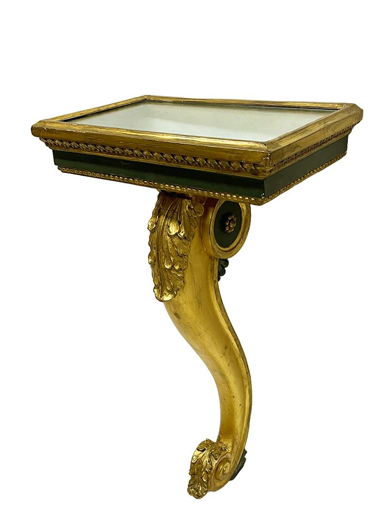 Italian console tables on a cabriole leg, ca 1800

A pair of Italian console tables in rectangular shape on a gilded cabriole leg, ca 1800. The tables are covered with mirror glass and the tables are gilded and have a gadroom lines, in between with