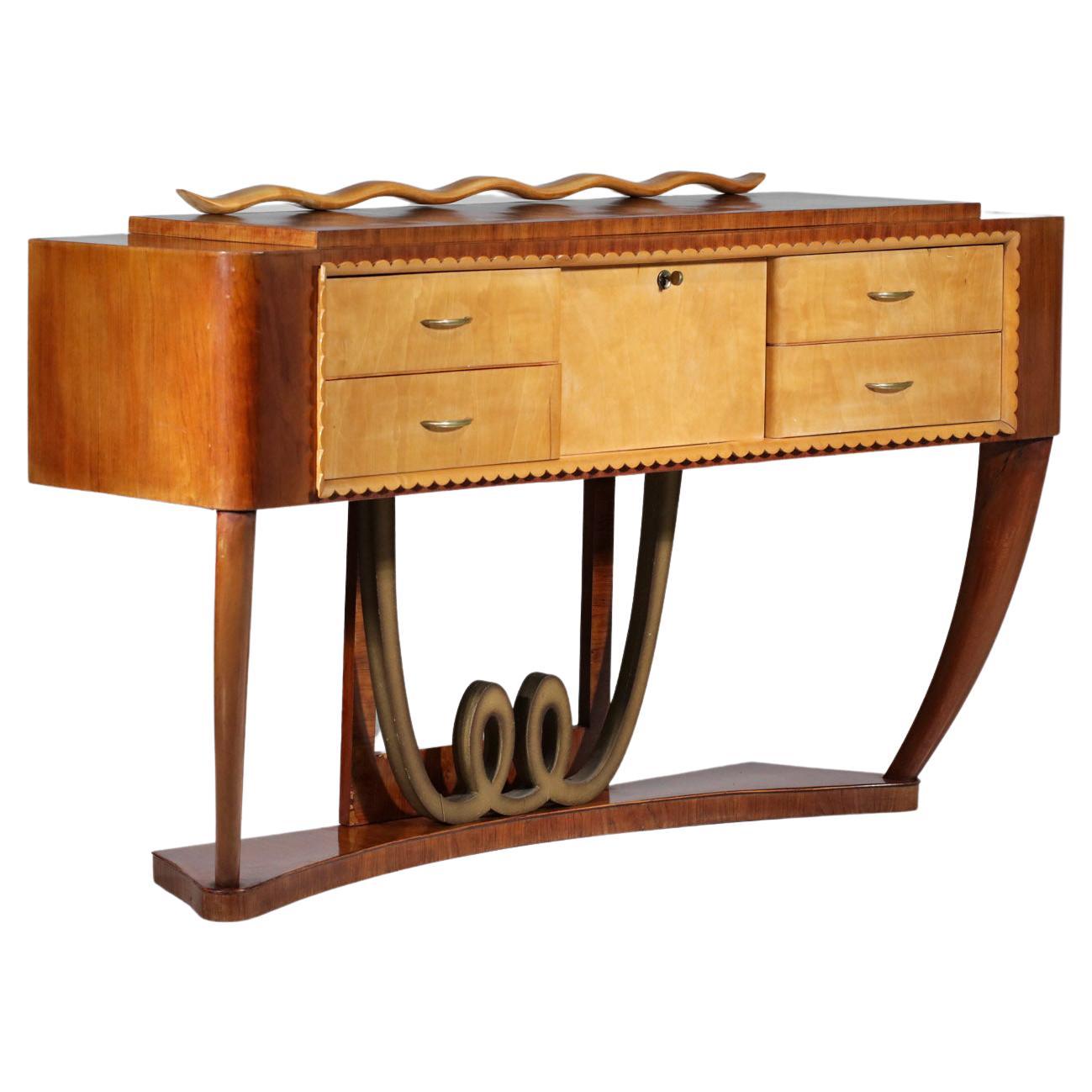 Italian sideboard from the 60's very decorative in the taste of Paolo Buffa or Gio Ponti's work. The set is made of different types of wood, veneered or solid. This sideboard has four drawers and a central door. Very nice details on the base, the