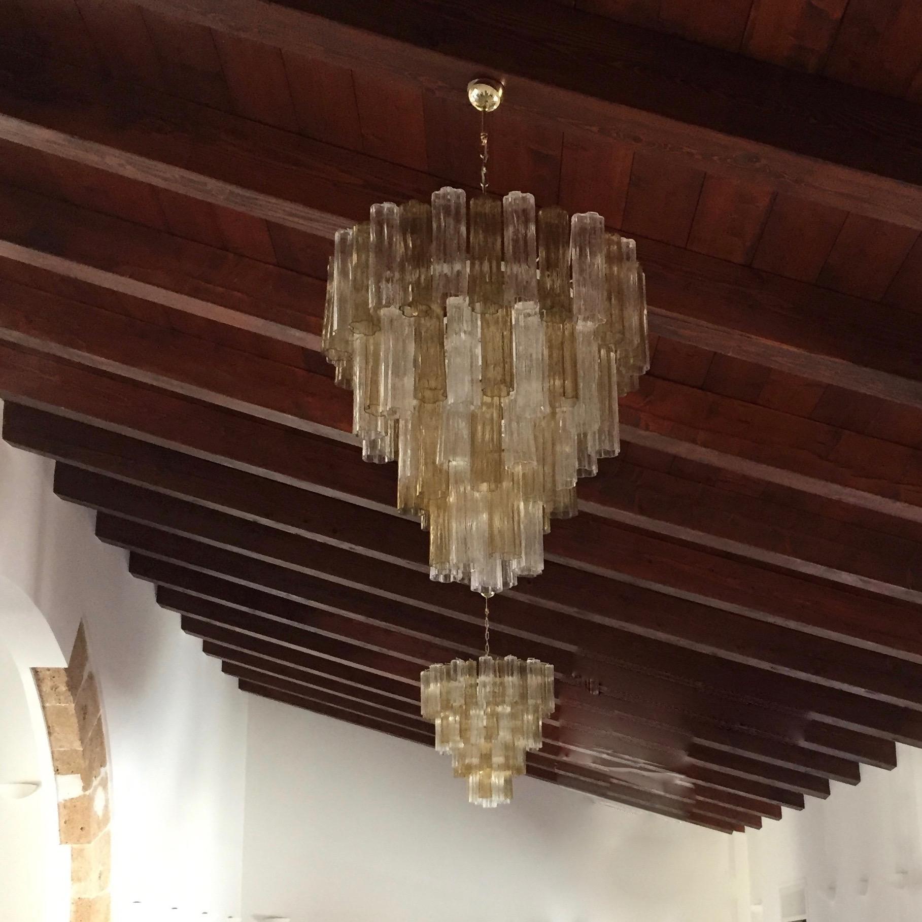 Midcentury design organic chandelier, entirely handcrafted in Italy, customizable in sizes, colors and finishes. The white lacquered metal structure supports large glass tubes called Tronchi, with star shape section, in blown Murano glass