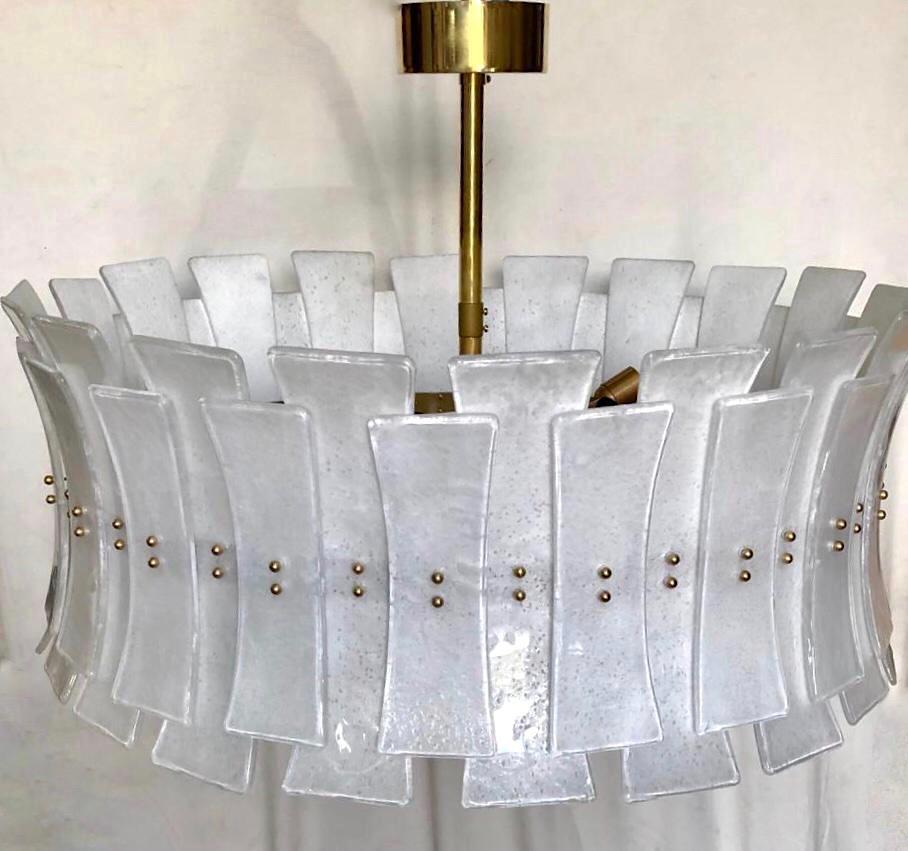 A contemporary Italian bespoke modern chandelier with Art Deco Design, entirely handcrafted in Italy, customizable as flushmounts or pendant chandelier with different glass colors and finishes, here with a brass structure in a minimalist geometric