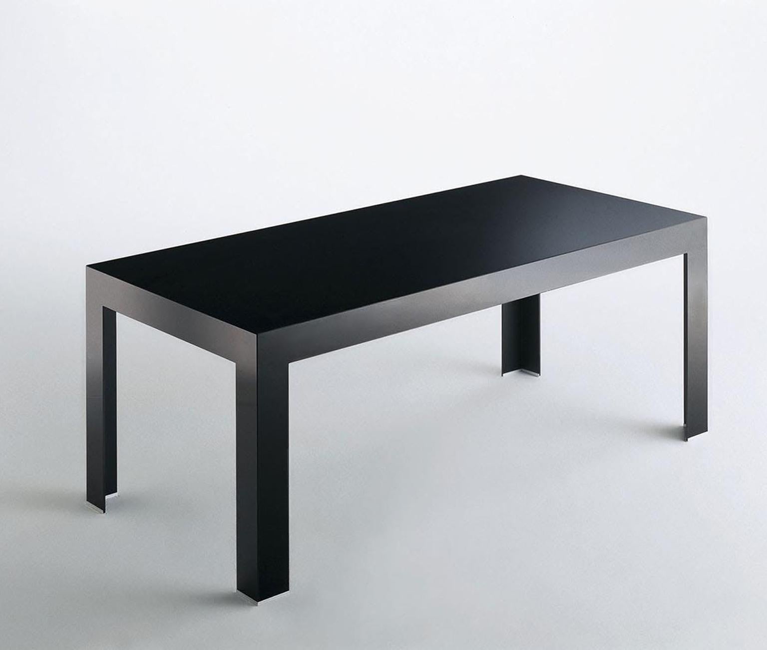 Italian contemporary design black glass dining table, fully made in Italy.

The principal features of this beautiful and very elegant table are: pureness of its shape, sobriety and sophisticated working techniques. The crystal panels are welded with