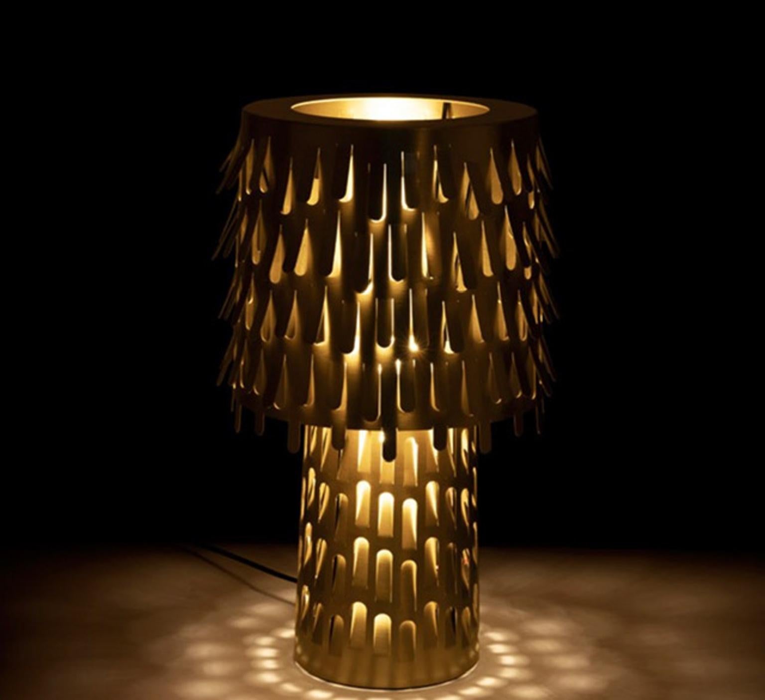 Stunning brass table lamp designed by Campana Brothers and totally  produced in Italy by Ghidini 1961, an historical brass factory.

The perforated structure and the opening of the metal lampshade create a suggestive radiations of light, a very