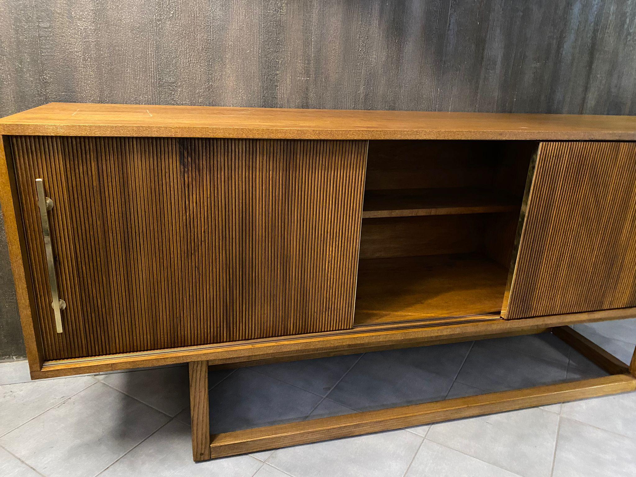 Beautiful sideboard designed and handcrafted by us with structure and interior in solid wood, a big rectangular leg , 3 sliding doors with vertical moldings and finishes in brass.
It is an object of high quality and refinement, ideal for giving