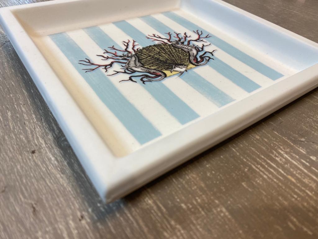 Elegant printed pocket tray represents marine elements such as shells corals seahorses on a delicate blue and white striped background. The finish is matt white.

Completely produced in Florence, Italy by Artecornici design. All articles all