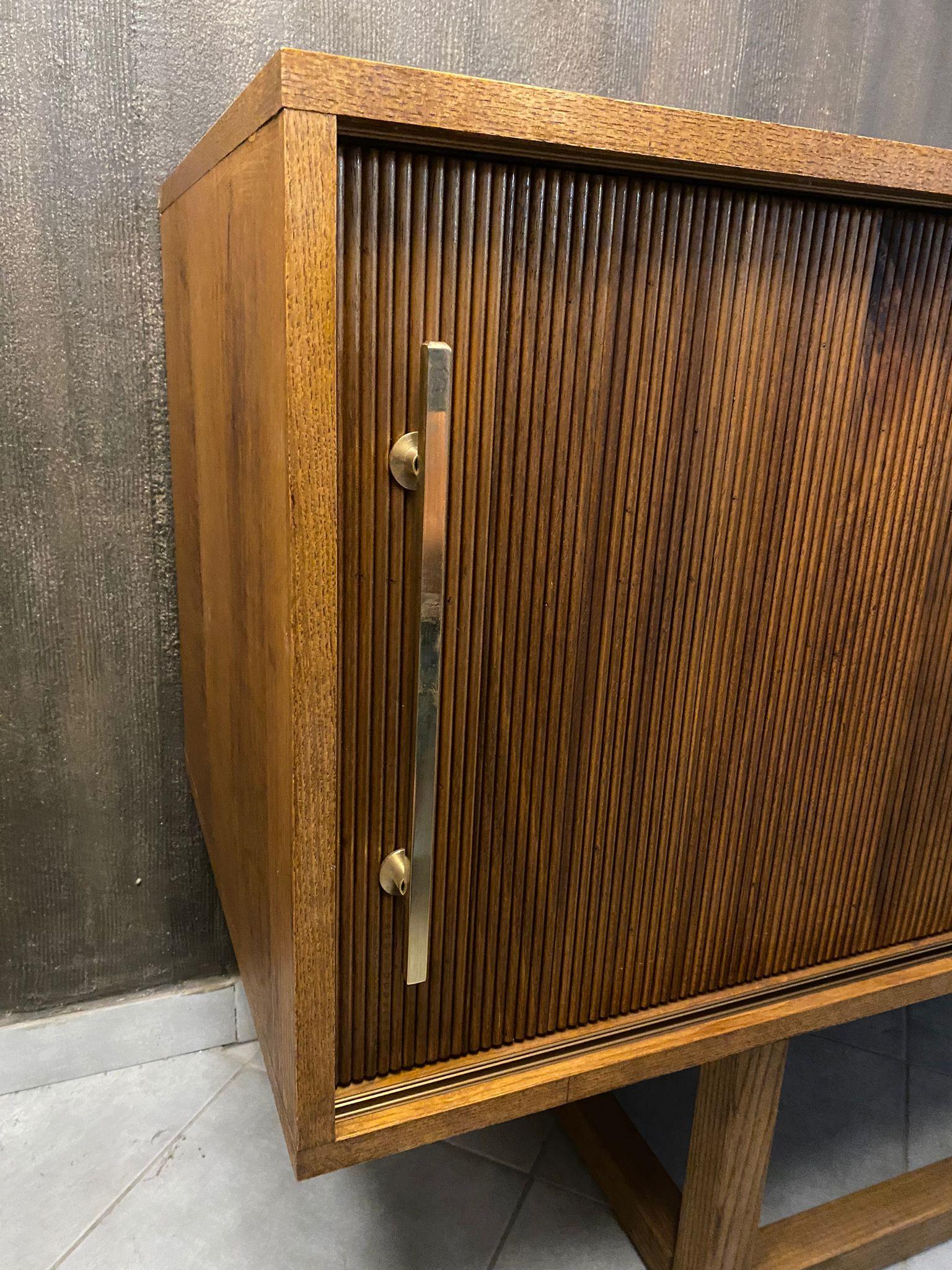 Beautiful sideboard designed and handcrafted by us with structure and interior in solid wood, a big rectangular leg , 3 sliding doors with vertical  geometric moldings and brass handles. In style of Mid-Century Modern and Brutalist Period.
It is an