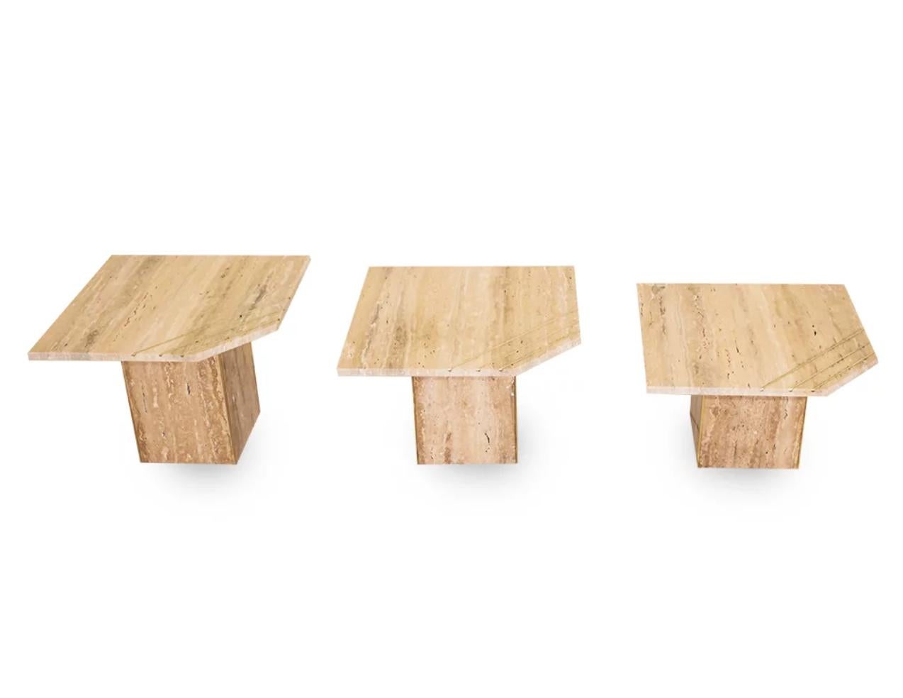 Travertine marble coffee table set, made in Italy, entirely hand crafted: 3 Ivory Cream Travertine Tables created at different heights to nest into each other, the geometric design is quite enticing with a cut corner and a brass decor with 3 inset